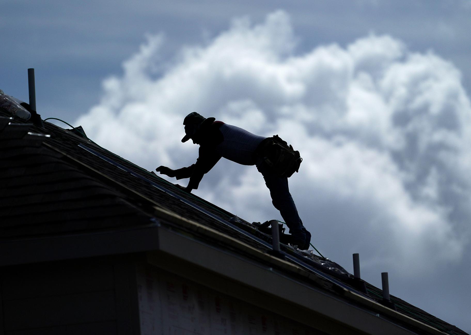 A roofer works on a new home under construction Thursday, July 18, 2019, in Houston. A heat wave is expected to send temperatures soaring close to 100 degrees through the weekend across much of the country. (AP Photo / David J. Phillip)