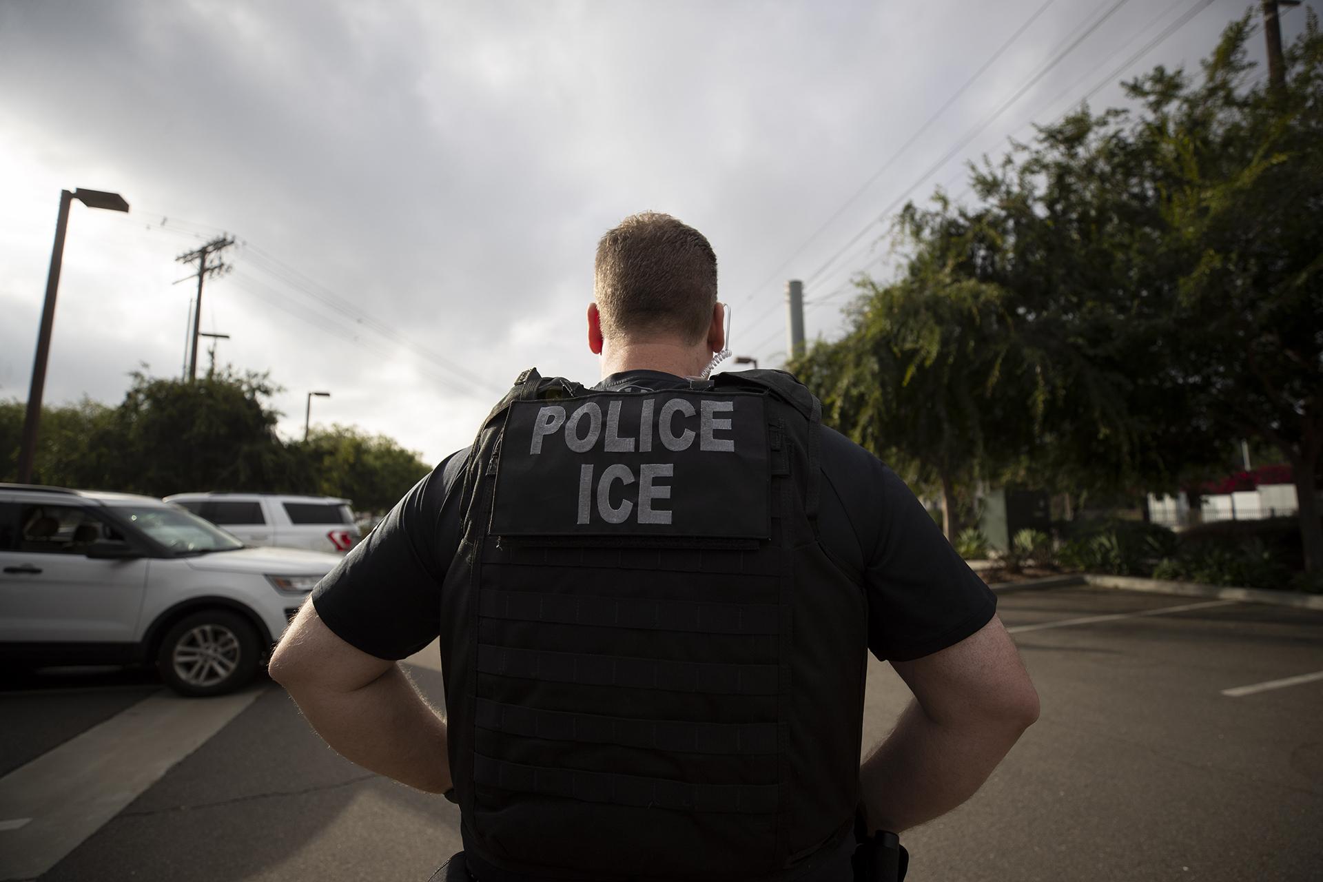 In this July 8, 2019, file photo, a U.S. Immigration and Customs Enforcement officer looks on during an operation in Escondido, California. (AP Photo / Gregory Bull, File)
