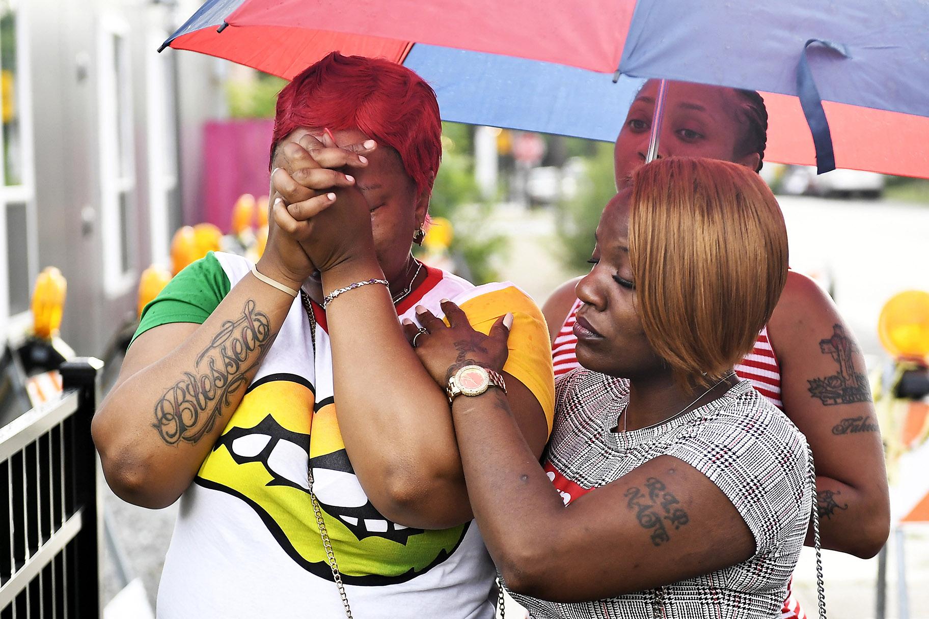  Charvonda Andrews is consoled Tuesday, July 30, 2019 in Chicago as she mourns two women killed July 26 while working as volunteers with a group called Mothers Against Senseless Killings. (John Alexander / Chicago Sun-Times via AP)