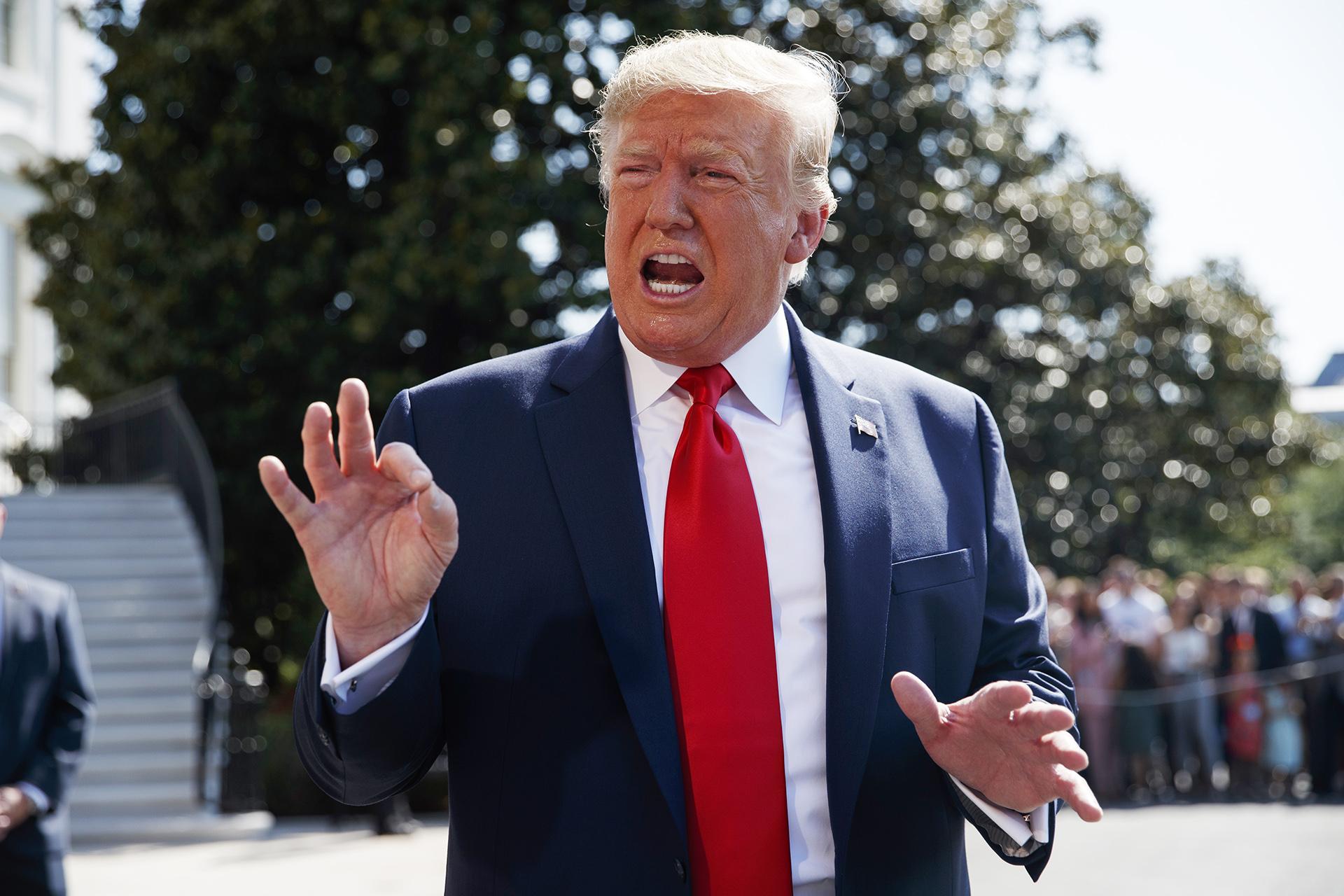 President Donald Trump talks to reporters on the South Lawn of the White House, Friday, Aug. 9, 2019, in Washington, as he prepares to leave Washington for his annual August holiday at his New Jersey golf club.  (AP Photo / Evan Vucci)