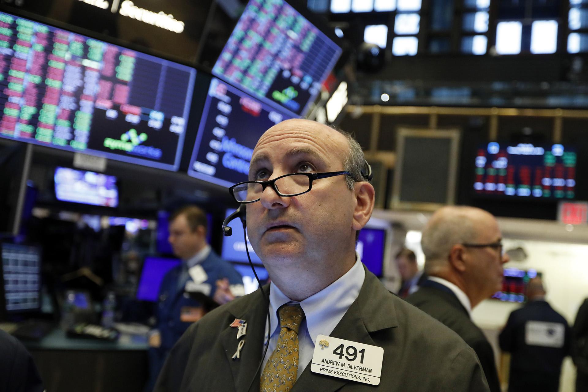 In this Tuesday, Aug. 13, 2019, file photo trader Andrew Silverman works on the floor of the New York Stock Exchange. (AP Photo / Richard Drew, File)