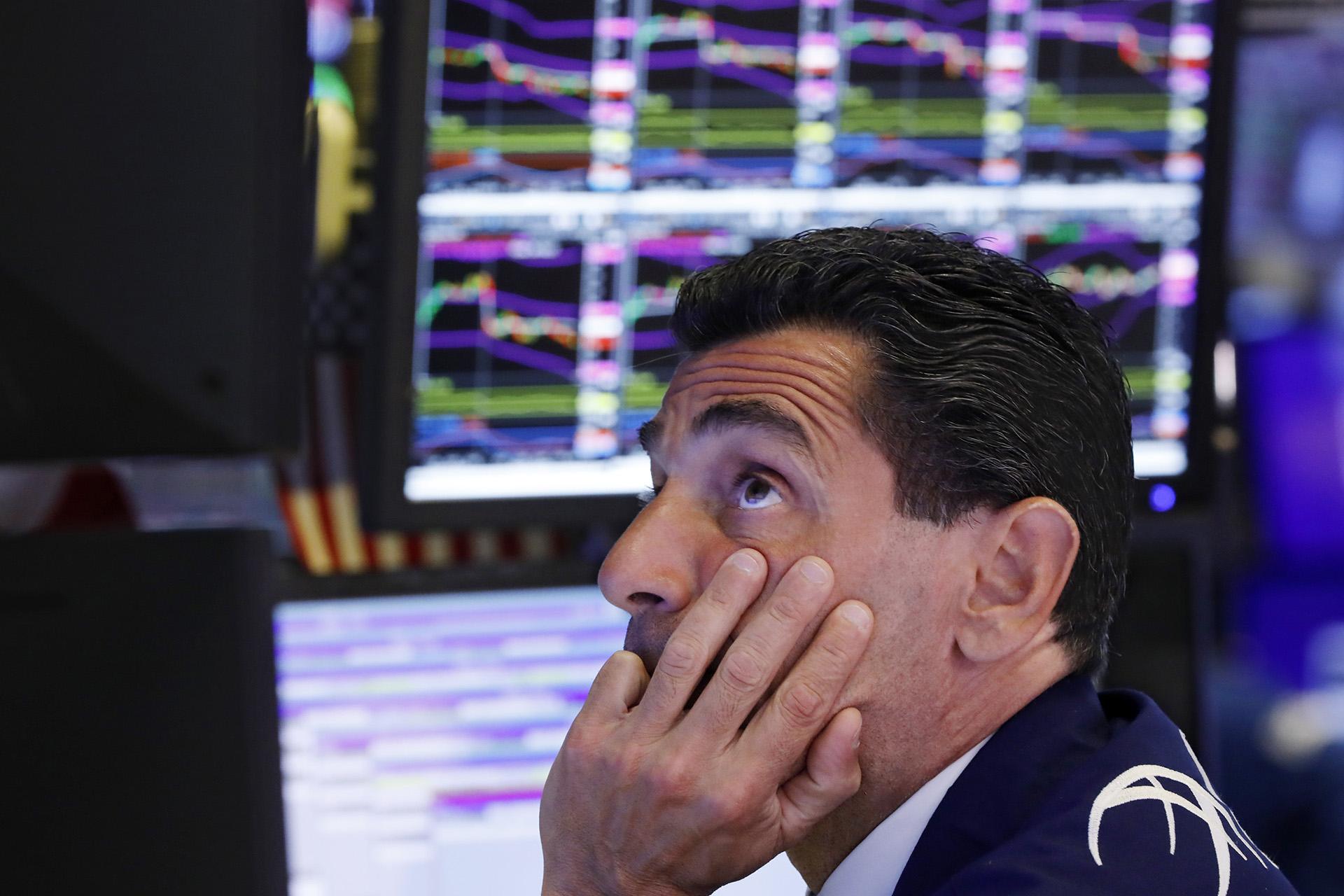 In this Aug. 12, 2019, photo specialist Peter Mazza works at his post on the floor of the New York Stock Exchange. (AP Photo / Richard Drew, File)