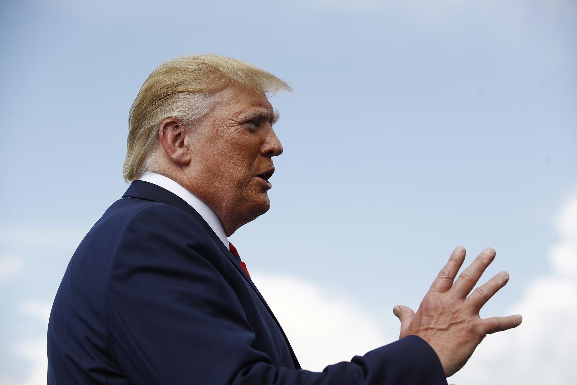 President Donald Trump speaks with reporters before boarding Air Force One at Morristown Municipal Airport in Morristown, New Jersey, Sunday, Aug. 18, 2019. (AP Photo / Patrick Semansky)