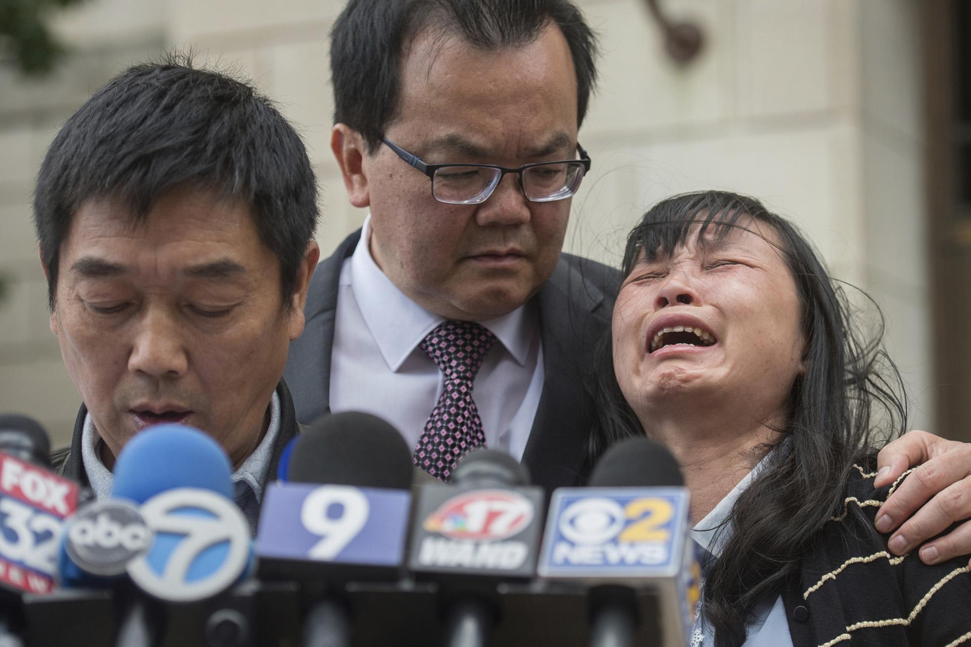  In this Monday, June 24, 2019 file photo, Lifeng Ye, the mother of slain University of Illinois scholar Yingying Zhang, cries out in grief as her husband Ronggao Zhang, left, addresses the media after a jury found Brendt Christensen guilty of Yingying Zhang’s murder, at the U.S. Federal Courthouse in Peoria, Illinois. Consoling her is family friend Dr. Kim Tee, center. (Matt Dayhoff / Journal Star via AP, File)