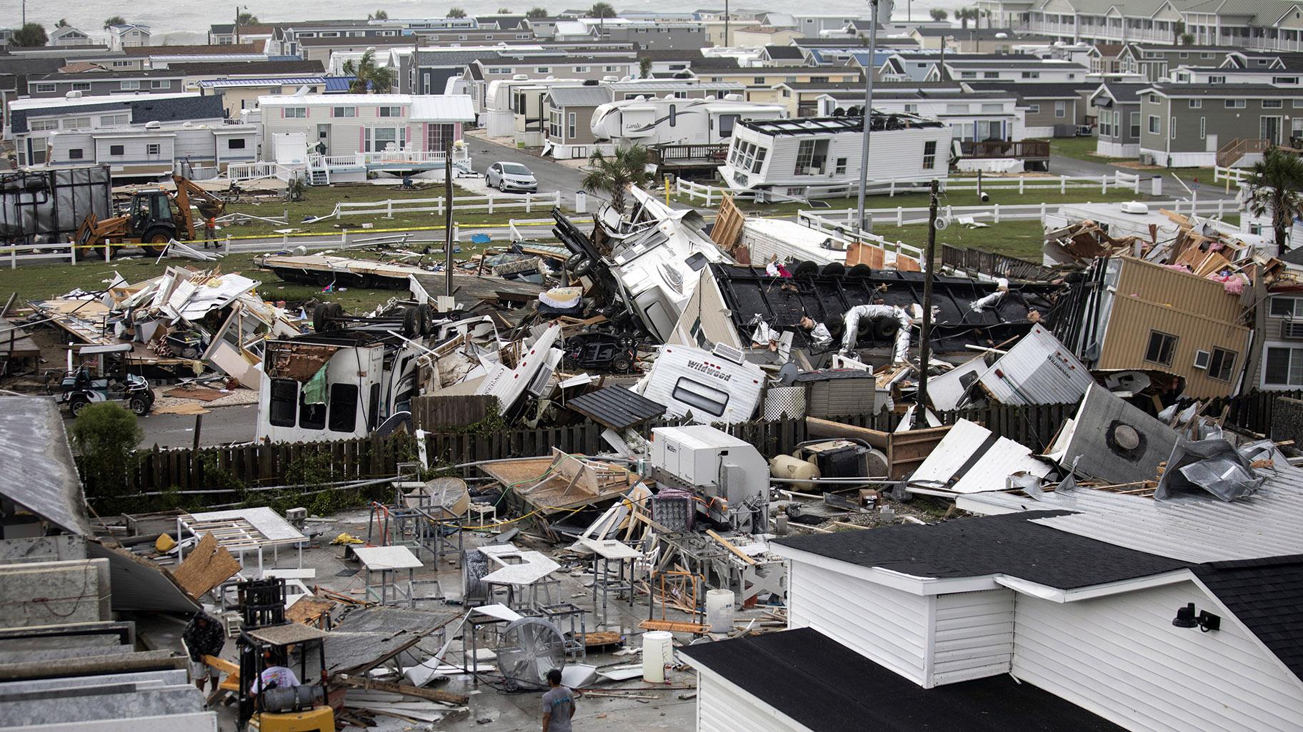 Mobile homes are upended and debris is strewn about at the Holiday Trav-l Park, Thursday, Sept. 5, 2019, in Emerald Isle, N.C, after a possible tornado generated by Hurricane Dorian struck the area. (Julia Wall / The News & Observer via AP)