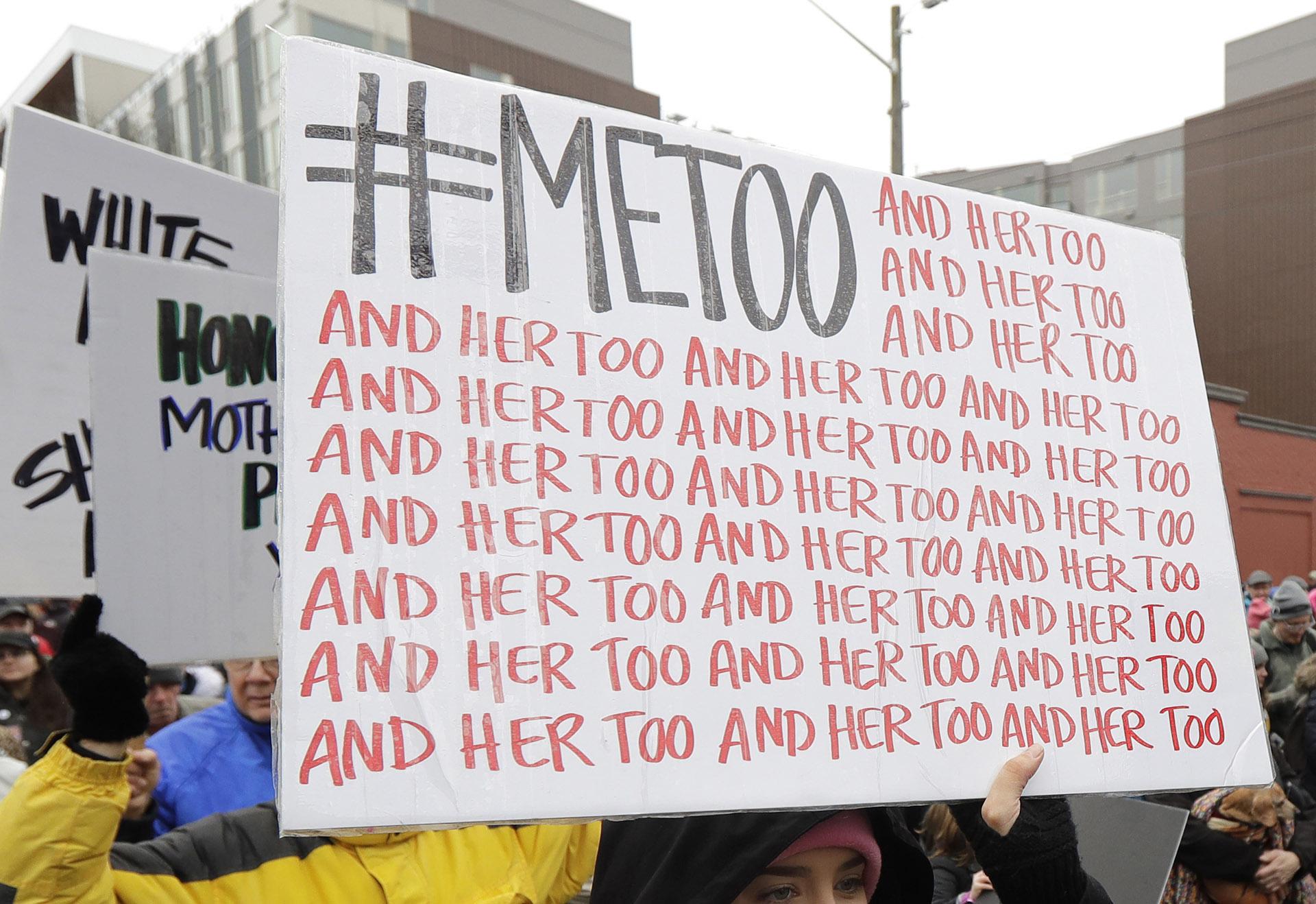In this Jan. 20, 2018 file photo, a marcher carries a sign with the popular Twitter hashtag #MeToo used by people speaking out against sexual harassment as she takes part in a Women’s March in Seattle.   (AP Photo / Ted S. Warren, File)