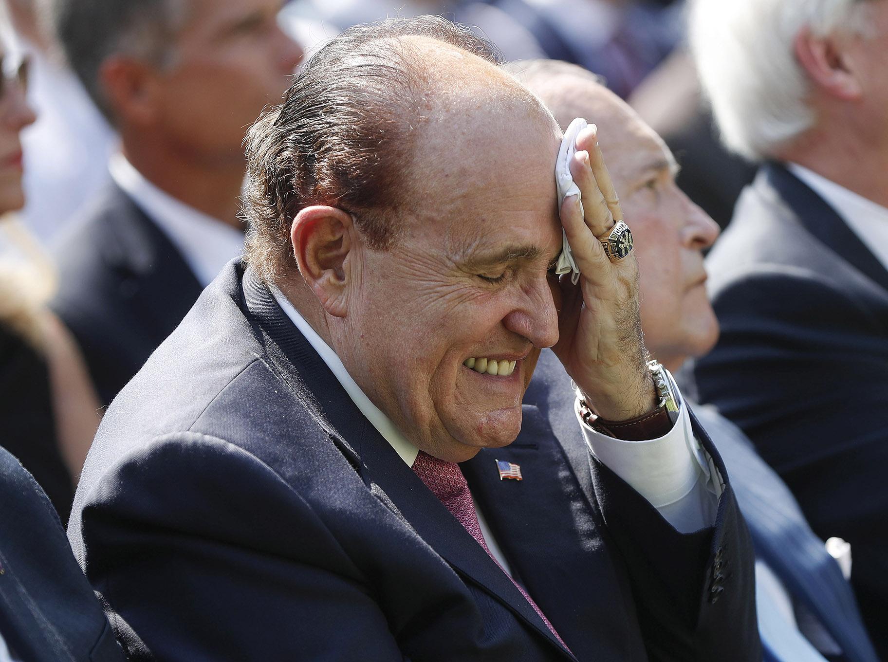 In this July 29, 2019 file photo, Rudy Giuliani, an attorney for President Donald Trump, wipes his forehead as he listens to Trump speak in the Rose Garden of the White House in Washington.  (AP Photo / Pablo Martinez Monsivais)