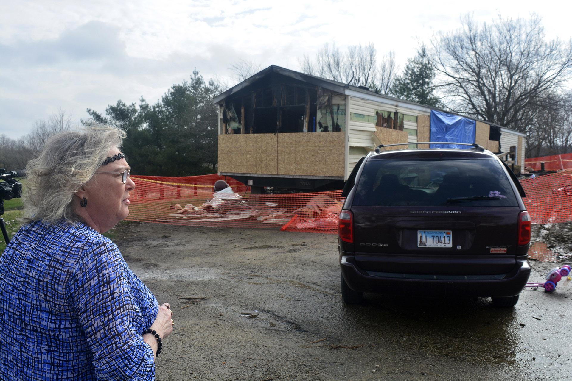 In this Sunday, April 7, 2019, file photo, Marie Chockley, a resident of the Timberline Trailer Court, north of Goodfield, Illinois, surveys the damage that was caused by a Saturday night fire that killed five residents in a mobile home. (Kevin Barlow / The Pantagraph via AP, File)