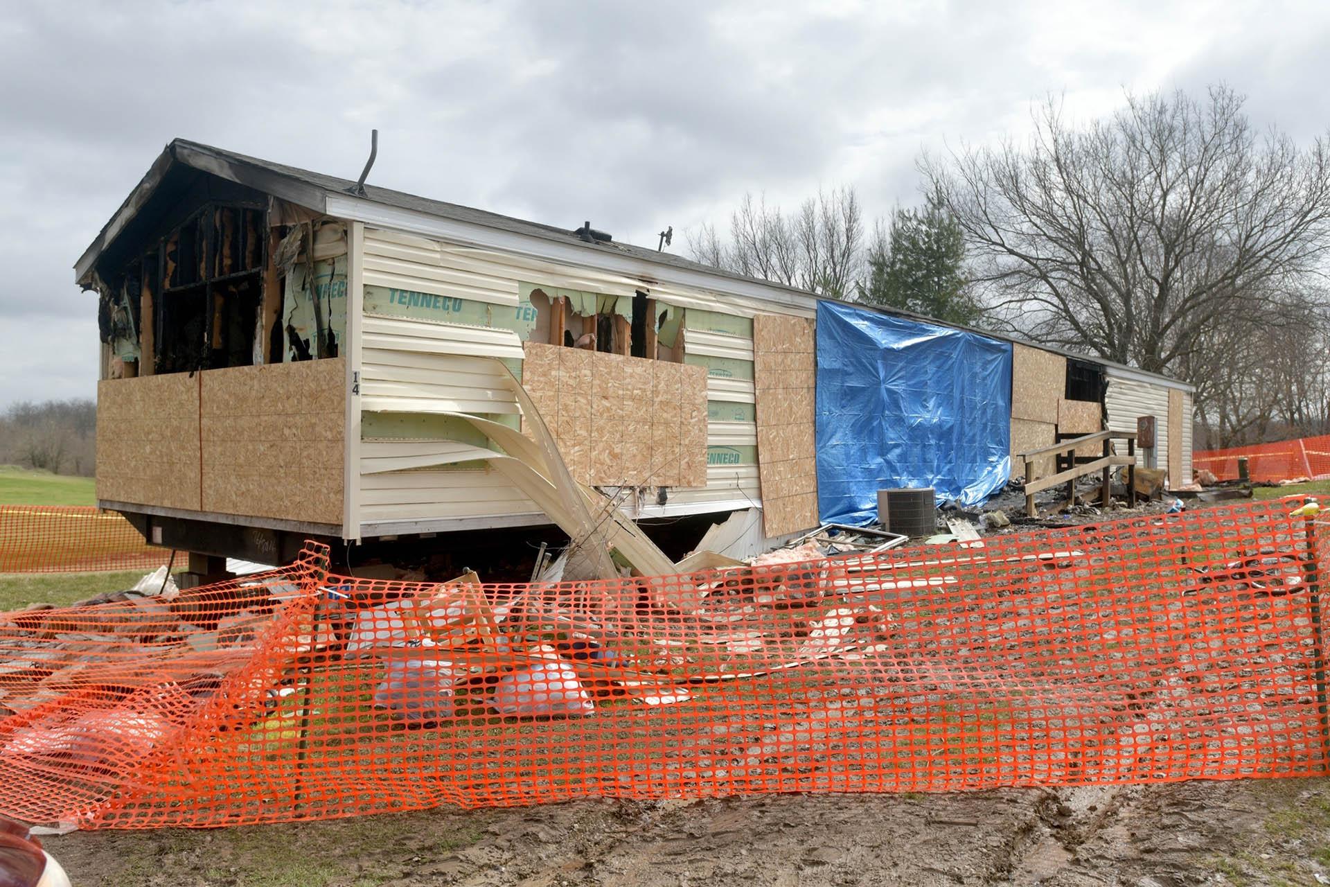 This photo taken April 7, 2019, shows a fence and caution tape surrounding a trailer home that was destroyed by fire in the Timberline Mobile Home Park northeast of Goodfield. (Matt Dayhoff / Journal Star via AP)
