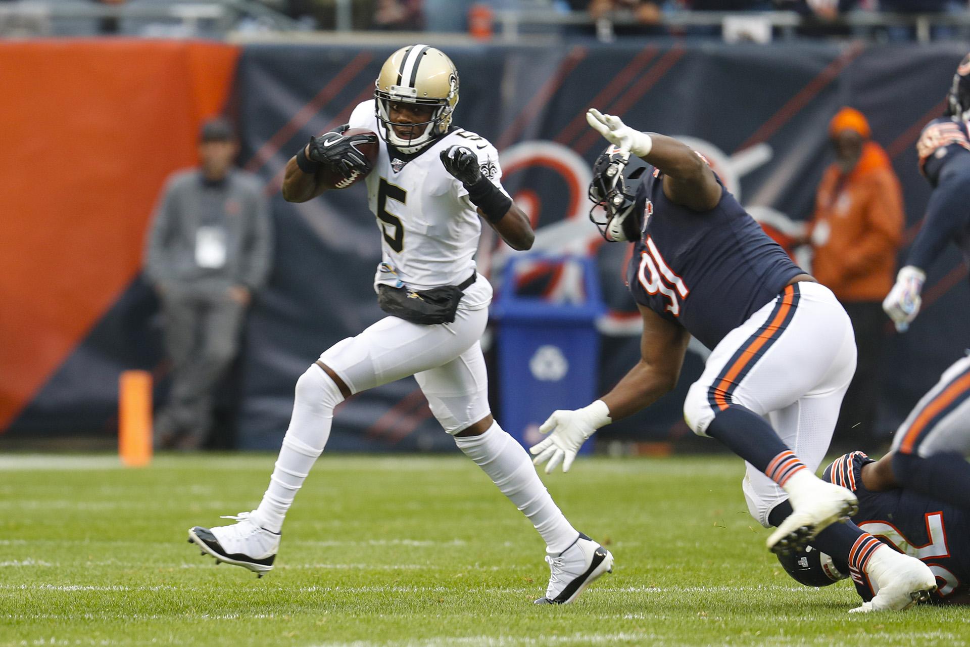 New Orleans Saints quarterback Teddy Bridgewater (5) is chased by Chicago Bears nose tackle Eddie Goldman (91) during the first half of an NFL football game in Chicago, Sunday, Oct. 20, 2019. (AP Photo / Charles Rex Arbogast)