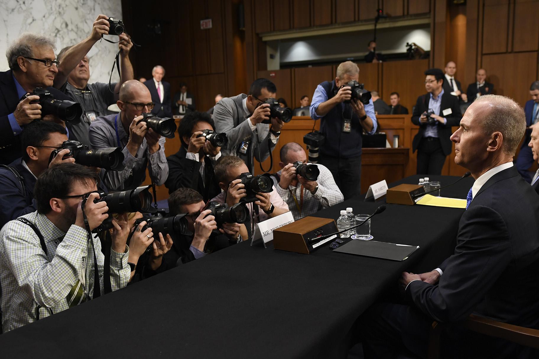 Boeing Company President and CEO Dennis Muilenburg, right, is surrounded by photographers on Capitol Hill in Washington, Tuesday, Oct. 29, 2019, before the start of a Senate Committee on Commerce, Science, and Transportation hearing on “Aviation Safety and the Future of Boeing’s 737 MAX.” (AP Photo / Susan Walsh)