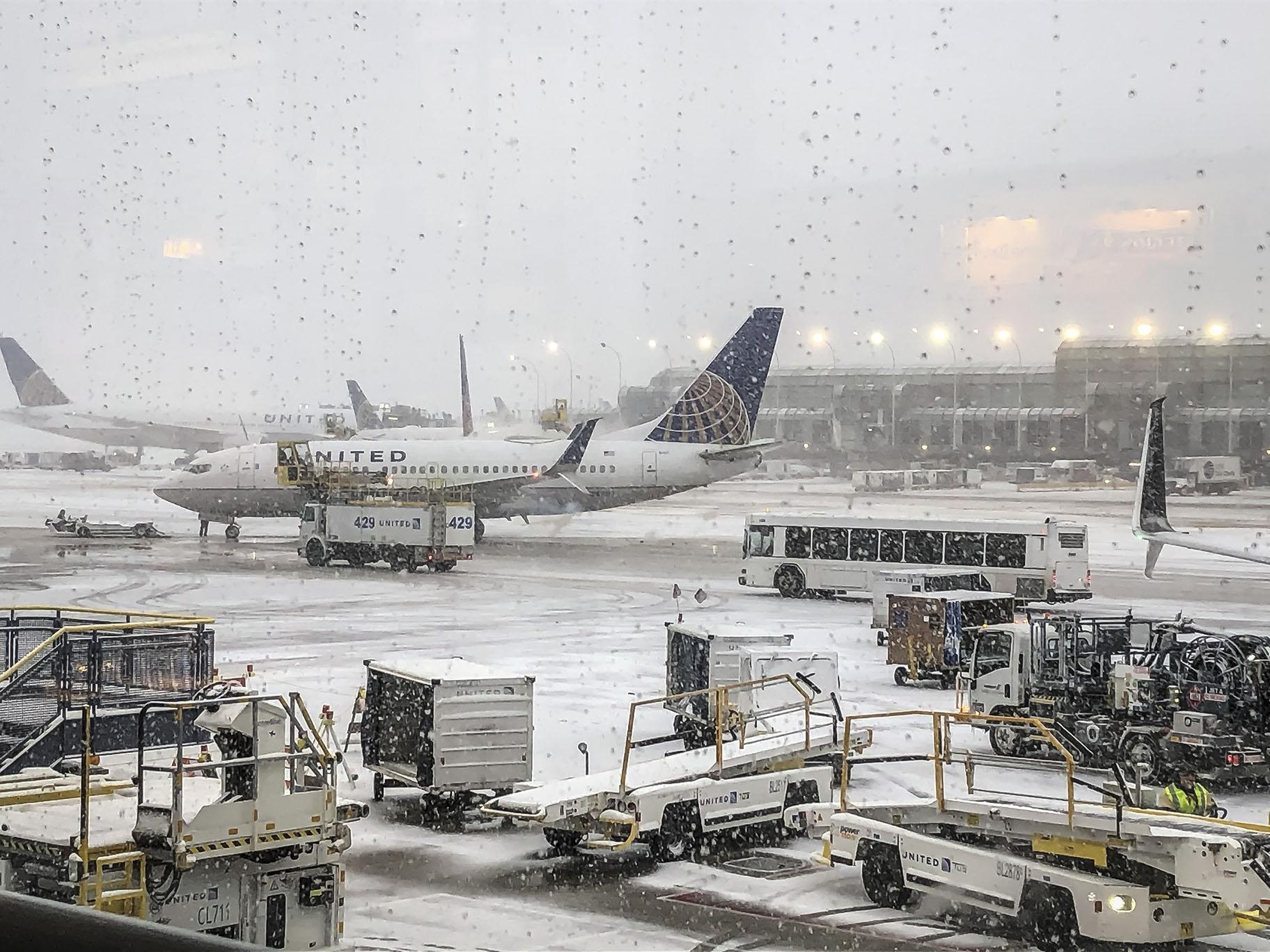 Snow falls on the United Terminal at O’Hare Airport in Chicago on Monday morning, Nov. 11, 2019. (Daryl Van Schouwen / Chicago Sun-Times via AP)