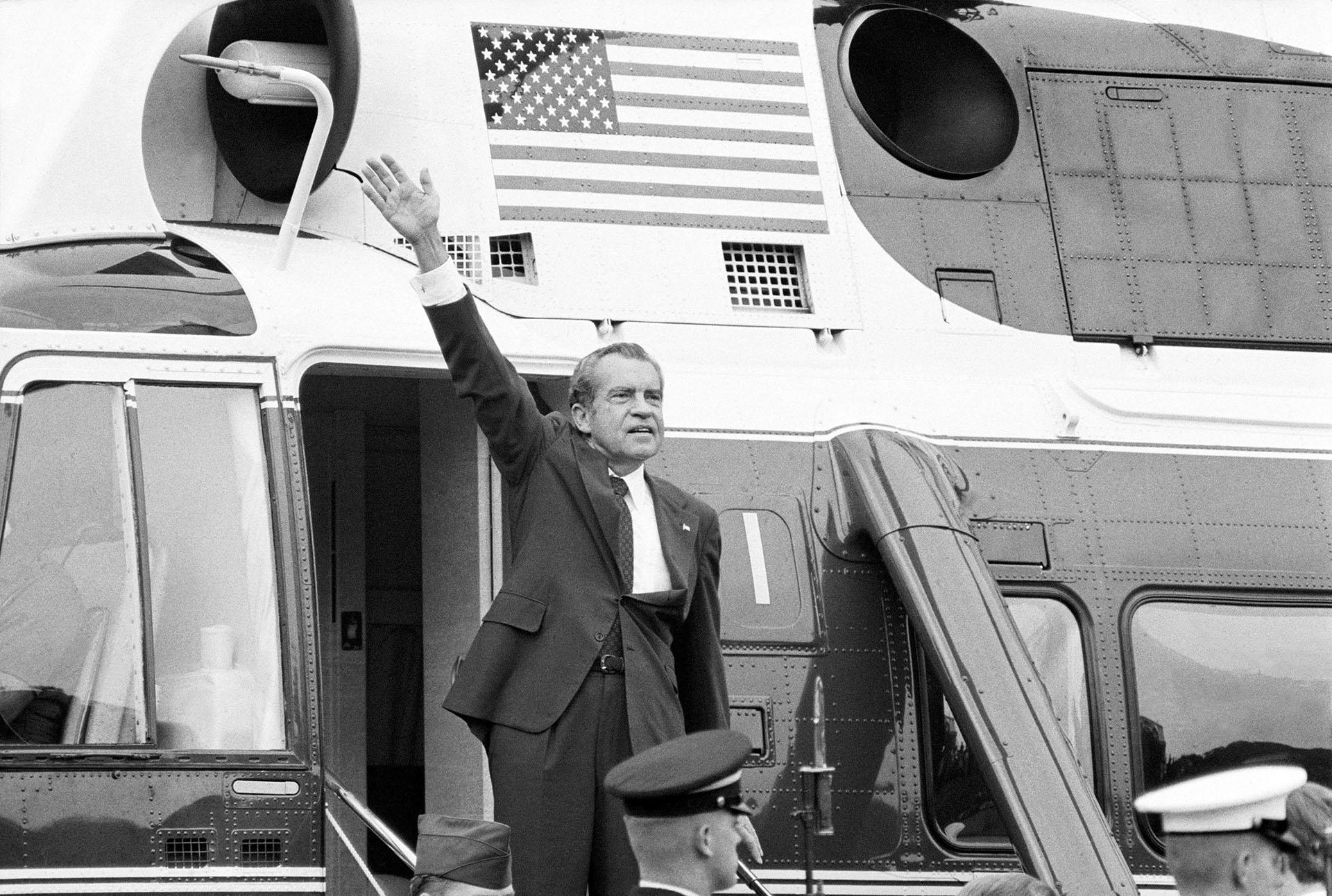 In this Aug. 9, 1974 file photo, President Richard Nixon waves goodbye from the steps of his helicopter outside the White House, after he gave a farewell address to members of the White House staff. (AP Photo / Chick Harrity) 