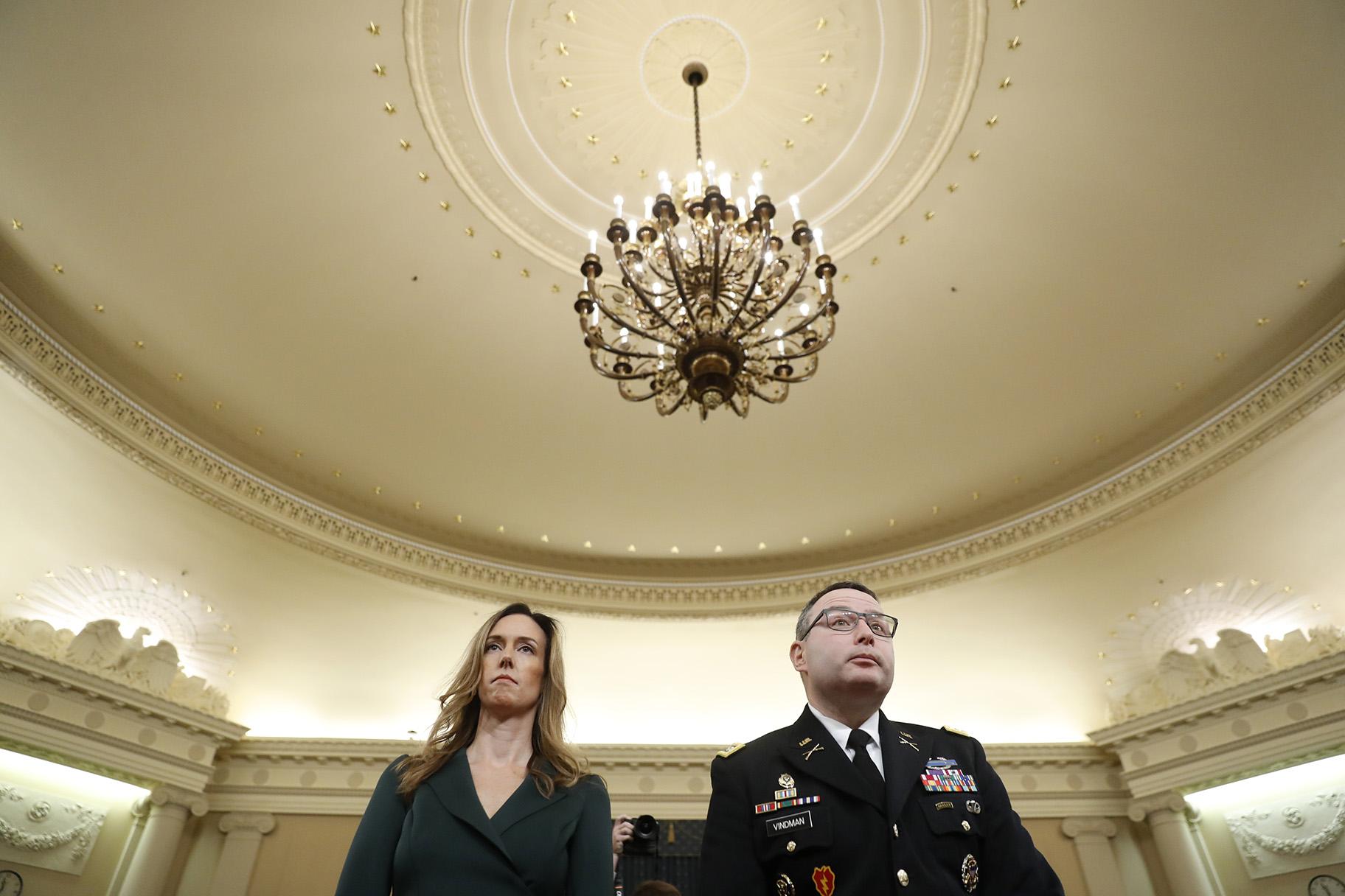 Jennifer Williams, an aide to Vice President Mike Pence, and National Security Council aide Lt. Col. Alexander Vindman stand as they take a break in hearing before the House Intelligence Committee on Capitol Hill in Washington, Tuesday, Nov. 19, 2019. (AP Photo / Andrew Harnik)