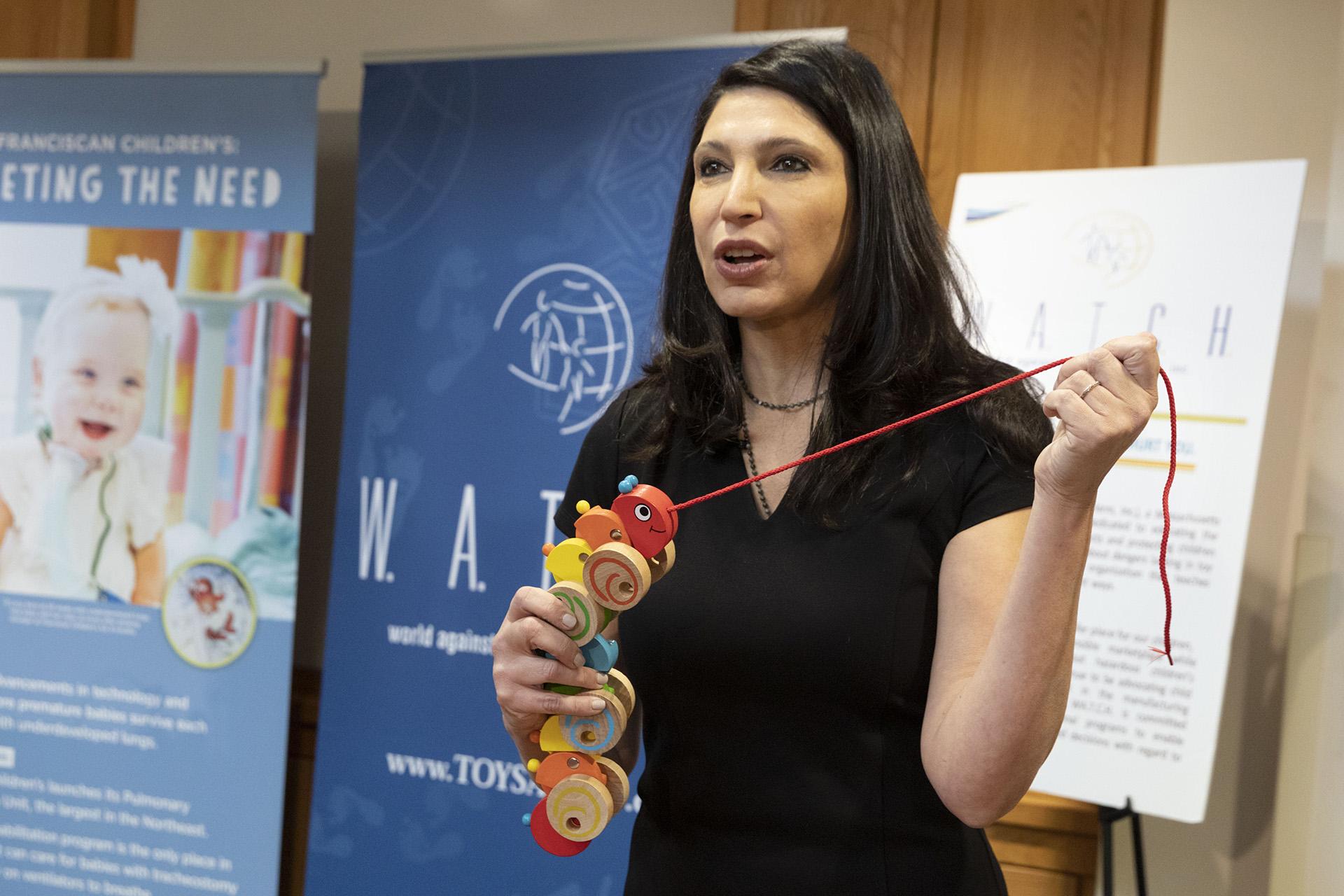 Joan Siff, president of World Against Toys Causing Harm, talks about the danger from strangulation of a pull-along caterpillar toy for infants during a news conference unveiling the organization’s list of worst toys for the holidays, Tuesday, Nov. 19, 2019, in Boston. (AP Photo / Michael Dwyer)