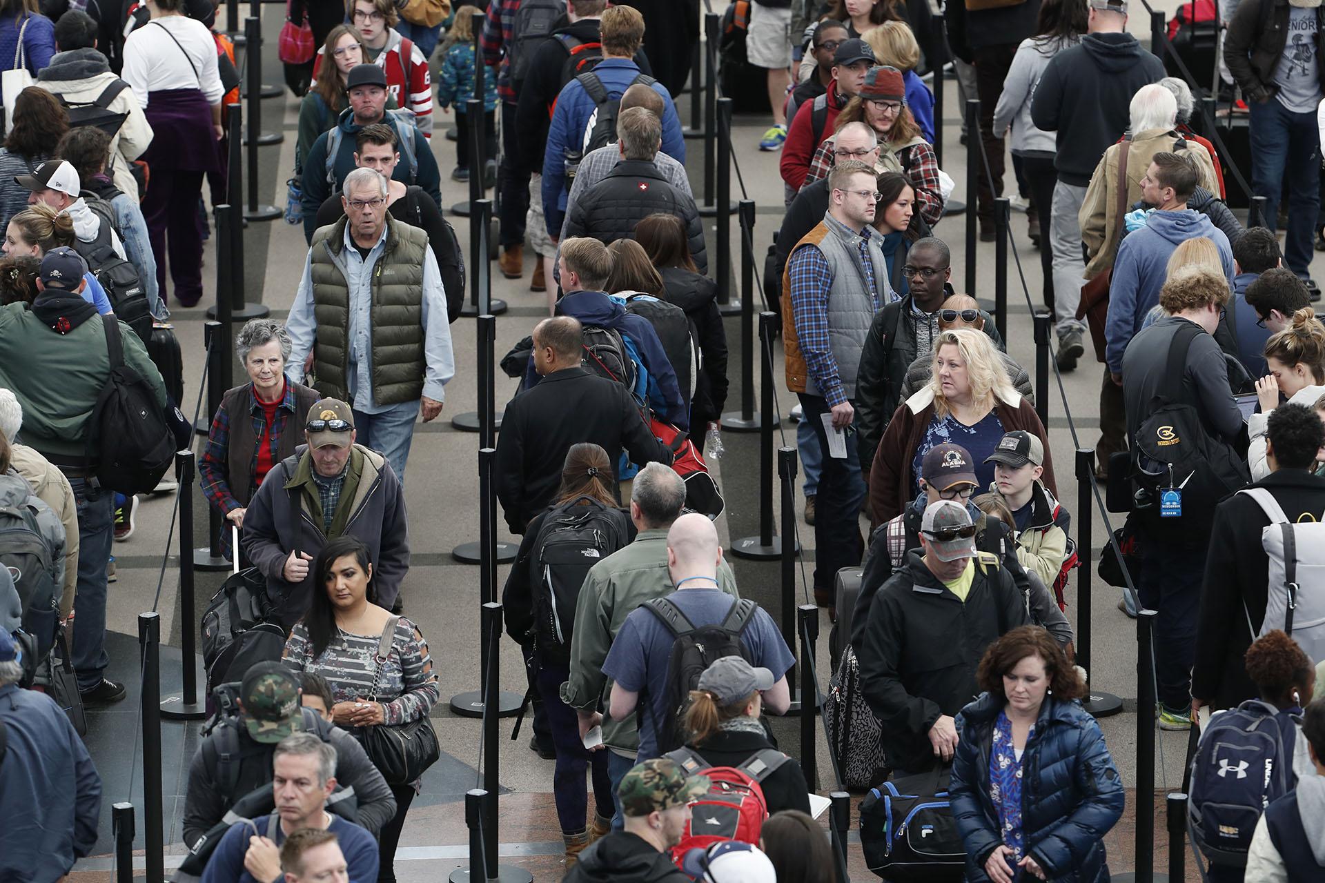 In this Nov. 21, 2018, file photo, travelers wait in long lines to pass through a security checkpoint at Denver International Airport in Denver. (AP Photo / David Zalubowski, File)