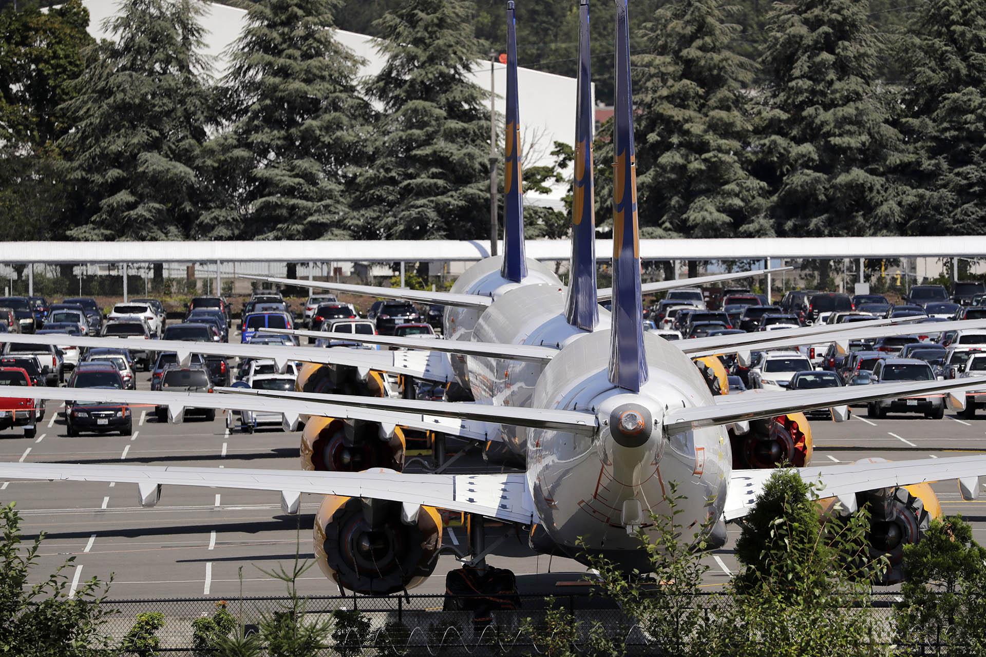 In this Thursday, Aug. 15, 2019, file photo, three grounded Boeing 737 Max airplanes, built for Icelandair, sit parked in a lot normally used for cars in an area adjacent to Boeing Field, in Seattle. (AP Photo / Elaine Thompson, File)