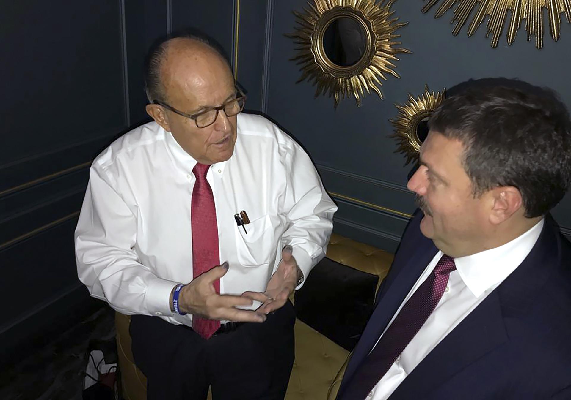 In this handout photo provided by Adriii Derkach’s press office, Rudy Giuliani, an attorney for U.S President Donald Trump, left, meets with Ukrainian lawmaker Adriii Derkach in Kyiv, Ukraine, Thursday, Dec. 5, 2019. (Adriii Derkach’s press office via AP)