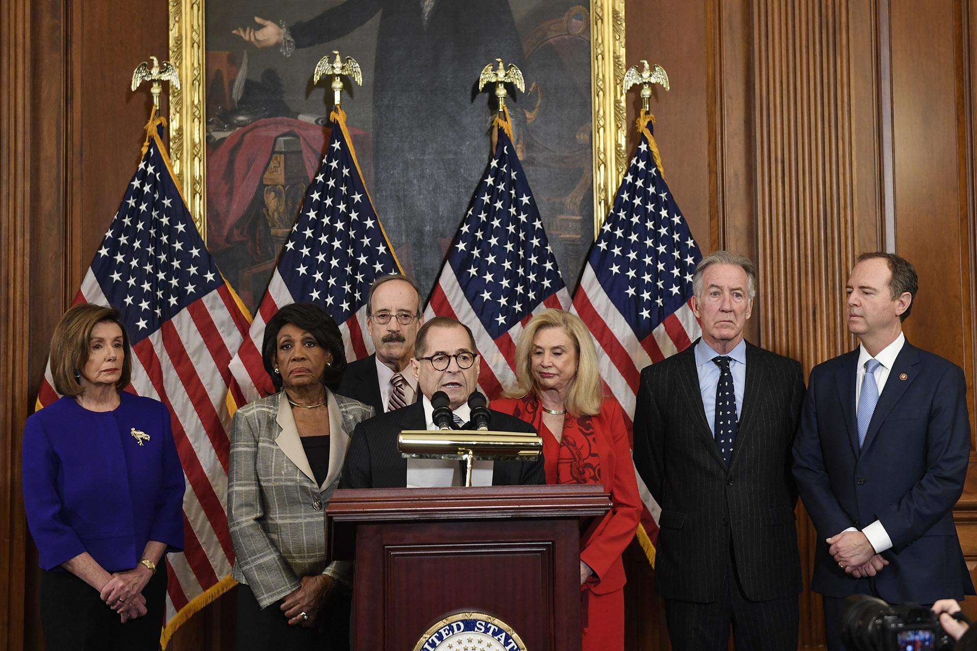From left House Speaker Nancy Pelosi, Chairwoman of the House Financial Services Committee Maxine Waters, D-Calif., Chairman of the House Foreign Affairs Committee Eliot Engel, D-N.Y., House Judiciary Committee Chairman Jerrold Nadler, D-N.Y., Chairwoman of the House Committee on Oversight and Reform Carolyn Maloney, D-N.Y., House Ways and Means Chairman Richard Neal and Chairman of the House Permanent Select Committee on Intelligence Adam Schiff, D-Calif., unveil articles of impeachment against President D