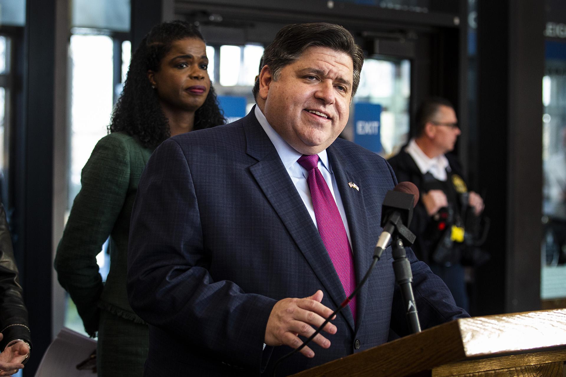 Cook County State’s Attorney Kim Foxx looks on as Illinois Gov. J.B. Pritzker speaks during a press conference in Chicago after Foxx filed motions to vacate more than 1,000 low-level cannabis convictions, Wednesday, Dec. 11, 2019. (Ashlee Rezin Garcia / Chicago Sun-Times via AP)