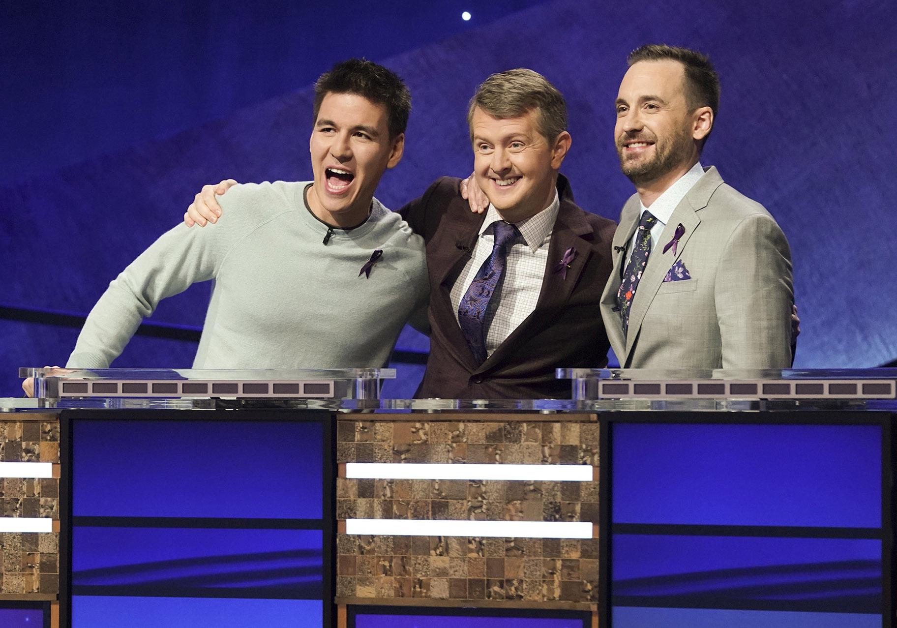 In this image released by ABC, contestants, from left, James Holzhauer, Ken Jennings and Brad Rutter appear on the set of “Jeopardy! The Greatest of All Time,” in Los Angeles. (Eric McCandless / ABC via AP)