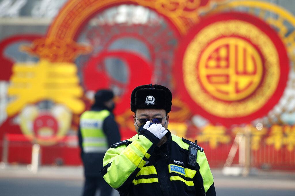 A traffic policeman adjusts his mask on a street in Beijing, Sunday, Feb. 9, 2020. (AP Photo / Andy Wong)