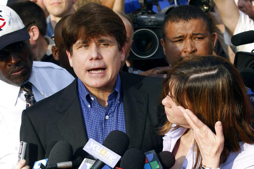 In this March 14, 2012, file photo, former Illinois Gov. Rod Blagojevich speaks to the media outside his home in Chicago as his wife, Patti, wipes away tears a day before reporting to prison after his conviction on corruption charges. (AP Photo / M. Spencer Green, File)