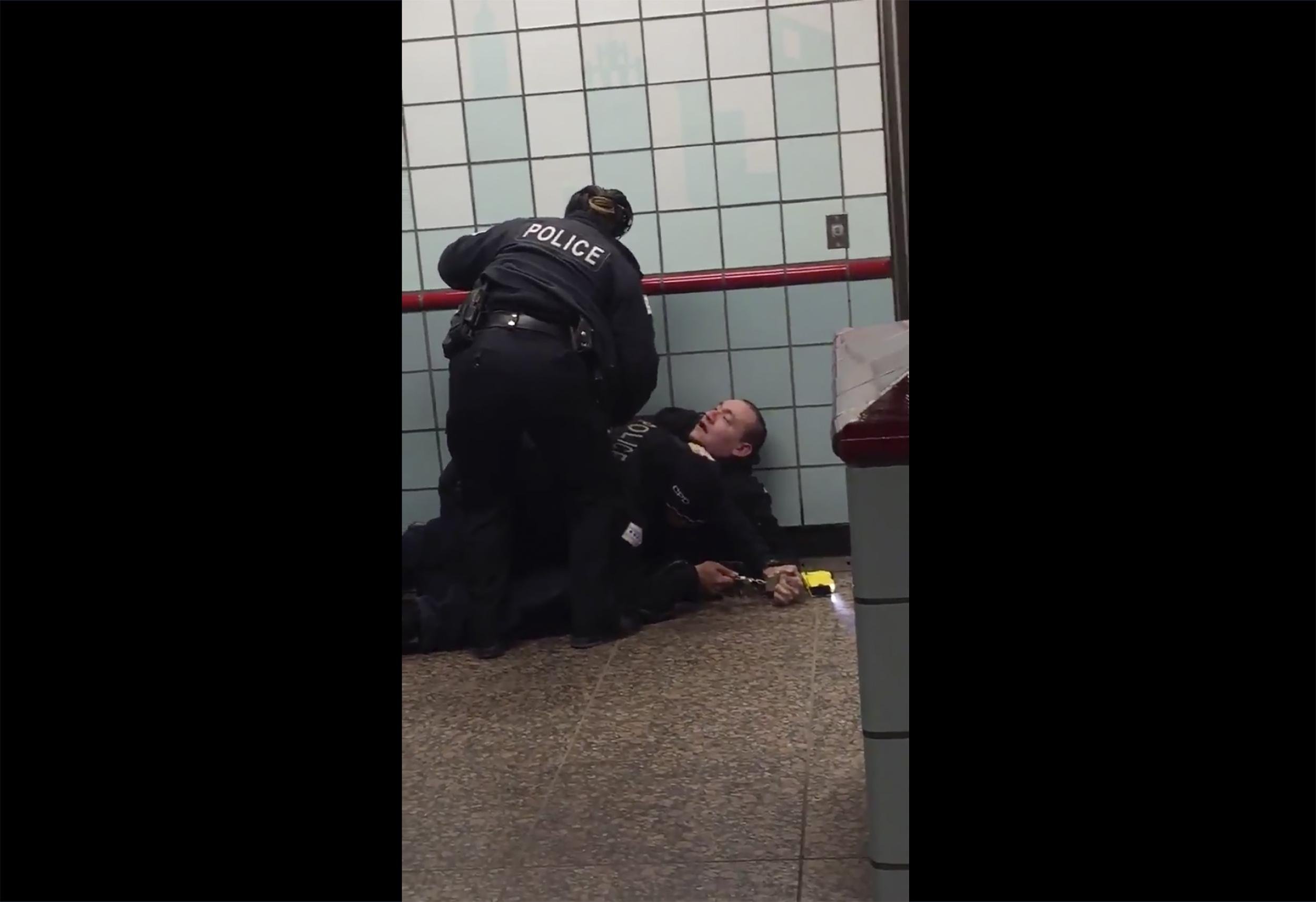 This Friday, Feb. 28, 2020 image from cellphone video shows Chicago police officers trying to apprehend a suspect inside a downtown Chicago train station. After a struggle with police, the suspect was shot as he fled up the escalator with the officers in pursuit. (Michael McDunnah via AP)