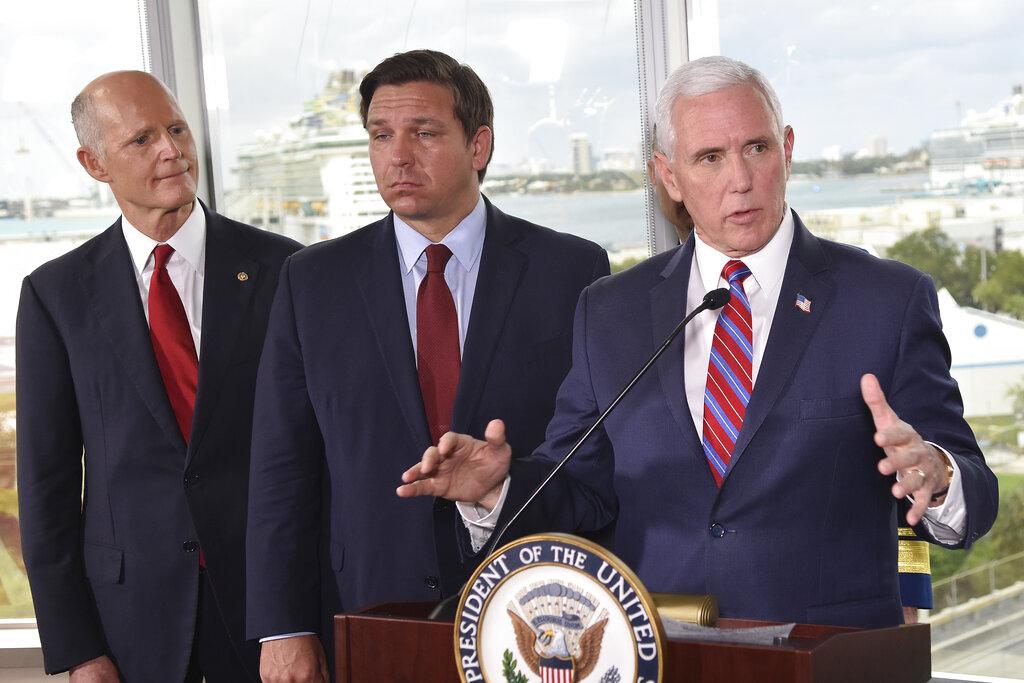Vice President Mike Pence, right, along with Florida Sen. Rick Scott, left, and Gov. Ron DeSantis, center, speaks to the media after a meeting with cruise line company leaders to discuss the efforts to fight the spread of the COVID-19 coronavirus, at Port Everglades, Saturday March 7, 2020, in Fort Lauderdale, Fla. (AP Photo / Gaston De Cardenas)