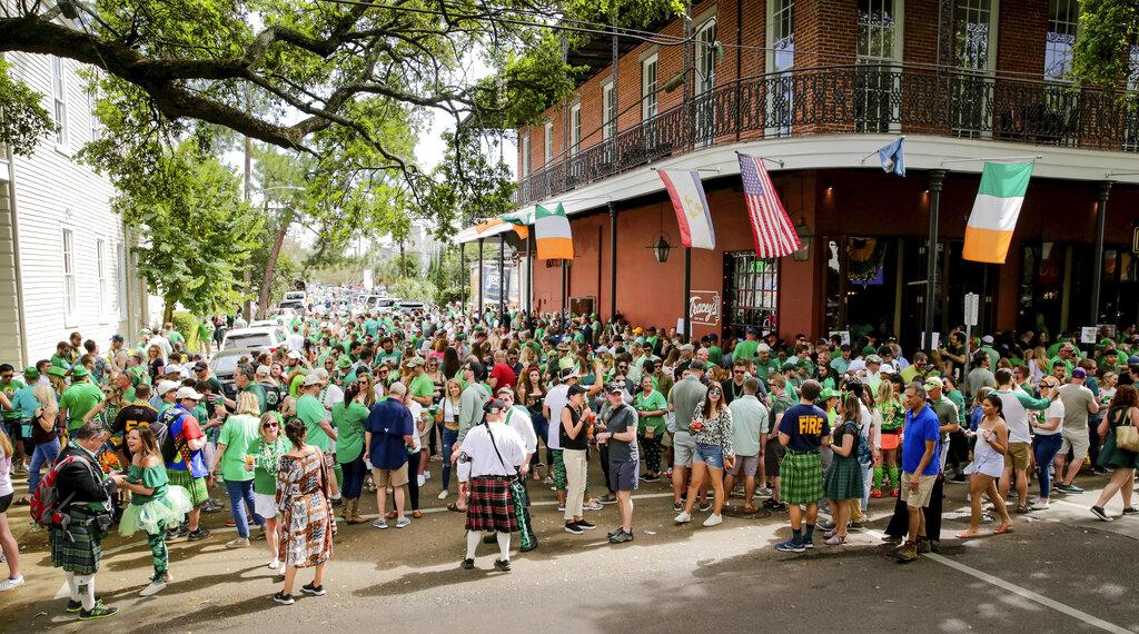 Revelers celebrate St. Patrick’s Day Saturday, March 14, 2020, during an unofficial gathering at Tracey’s Original Irish Channel Bar in New Orleans. (Scott Threlkeld / The Advocate via AP)