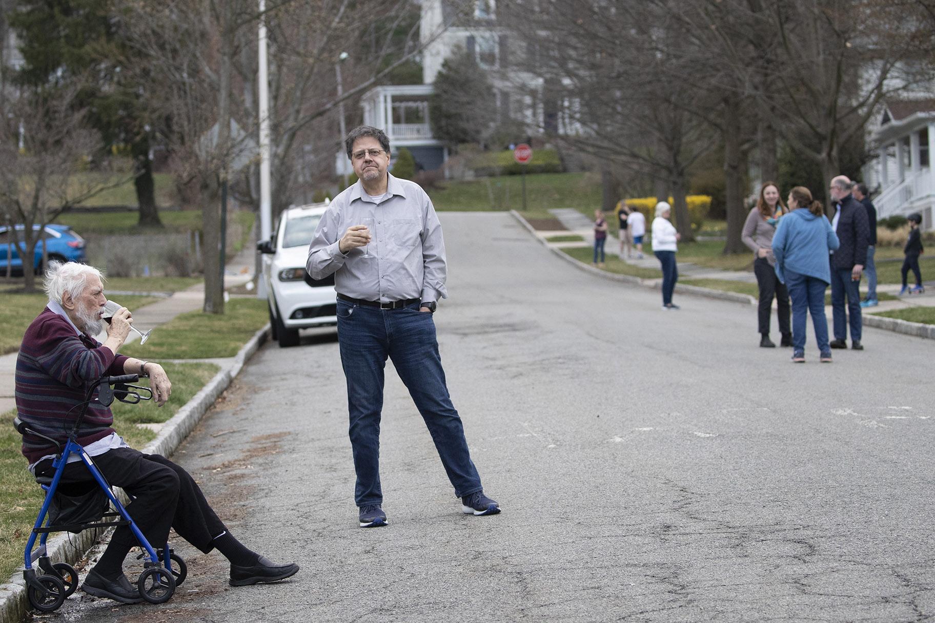 Residents of Brookfield Road in Montclair, N.J., get together for a street happy hour toast Friday, March 20, 2020. (AP Photo / Mary Altaffer)