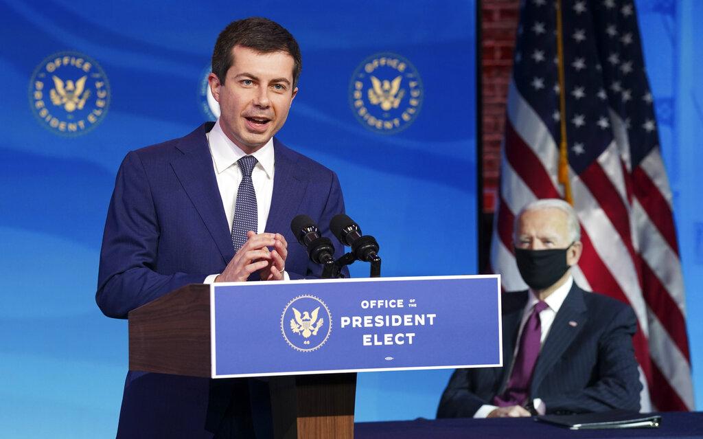 Former South Bend, Ind. Mayor Pete Buttigieg, President-elect Joe Biden's nominee to be transportation secretary reacts to his nomination as Biden looks on during a news conference at The Queen theater in Wilmington, Del., Wednesday, Dec. 16, 2020. (Kevin Lamarque / Pool via AP)