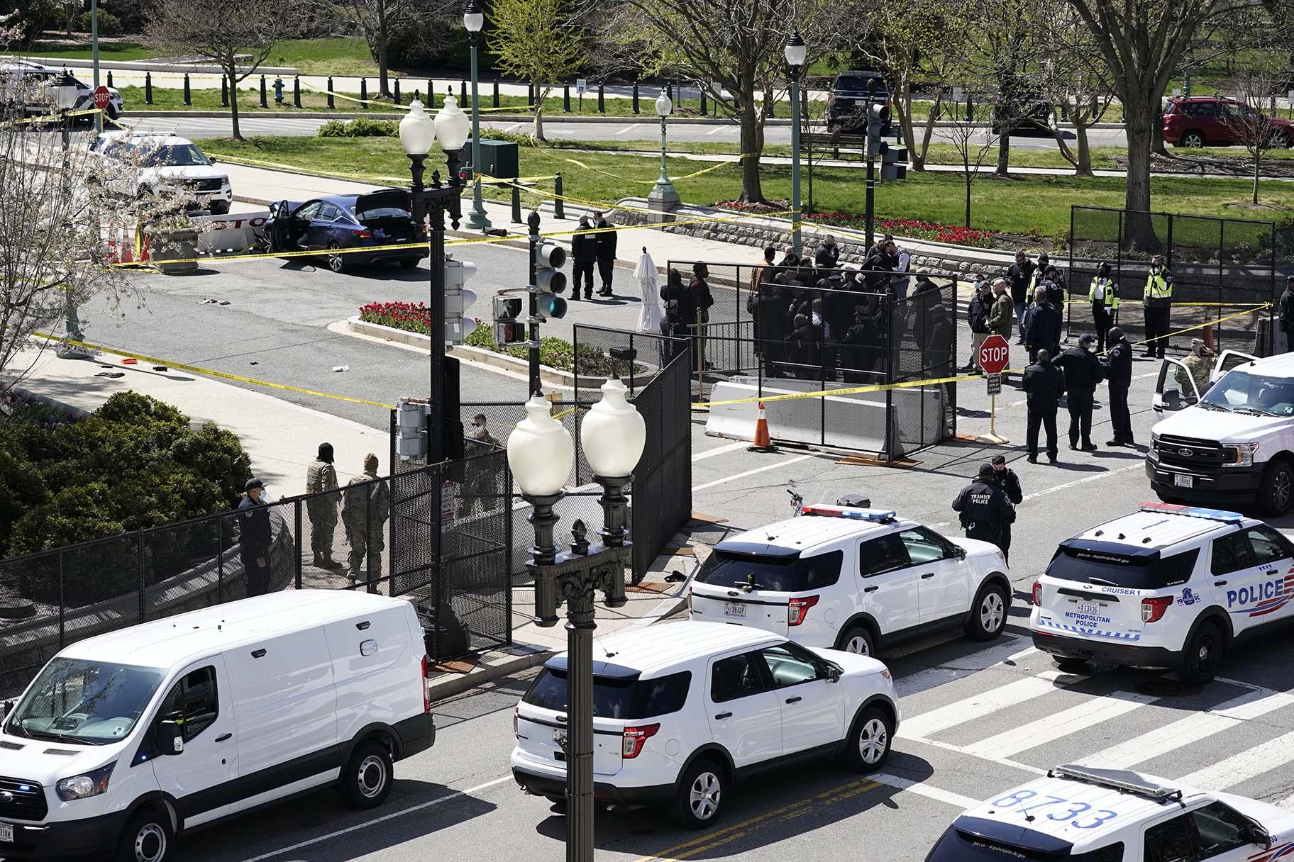 Police officers gather near a car that crashed into a barrier on Capitol Hill in Washington, Friday, April 2, 2021. (AP Photo / J. Scott Applewhite)