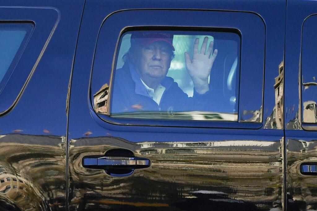 President Donald Trump waves to supporters from his motorcade as people gather for a march Saturday, Nov. 14, 2020, in Washington. (AP Photo / Julio Cortez)