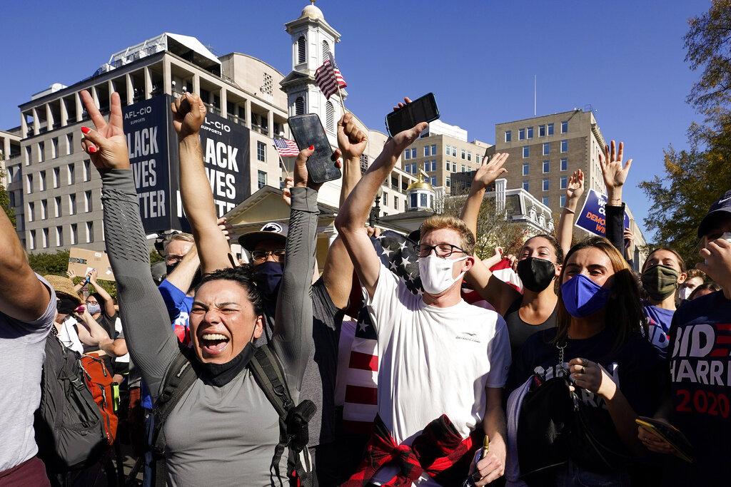 People gathered in Black Lives Matter Plaza react to the presidential race being called by CNN in Democratic presidential candidate Joe Biden’s favor over Pres. Donald Trump to become the 46th president of the United States, Saturday, Nov. 7, 2020, in Washington. (AP Photo / Alex Brandon)