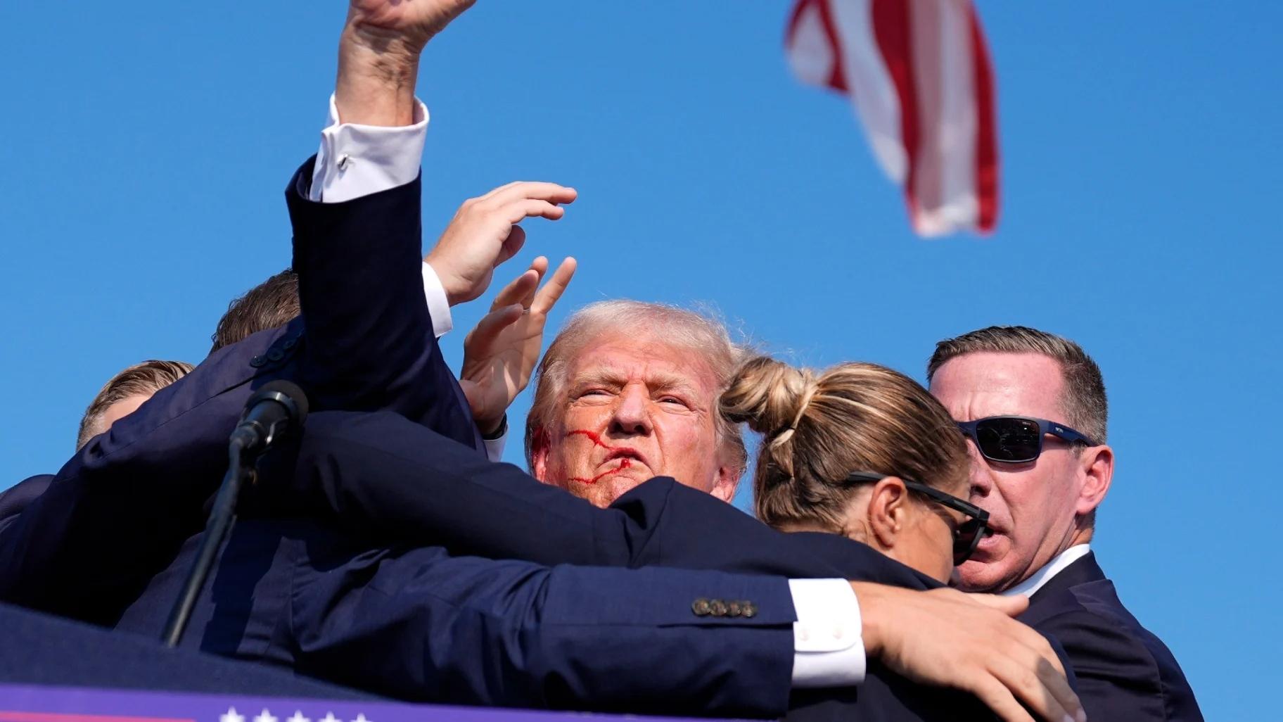 Republican presidential candidate former President Donald Trump is surrounded by U.S. Secret Service agents at a campaign rally, Saturday, July 13, 2024, in Butler, Pa. (Evan Vucci / AP Photo)