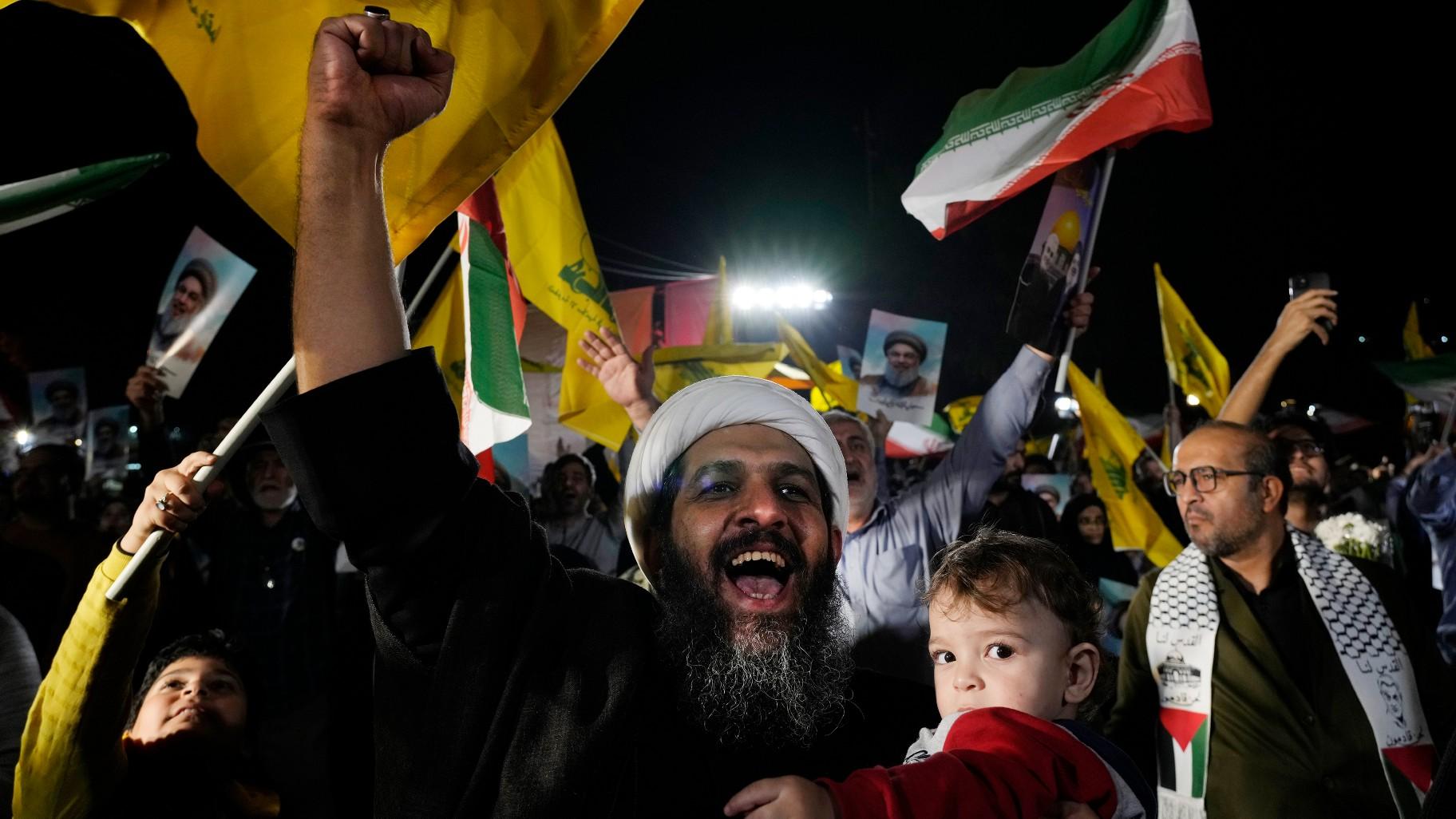 A cleric clenches his fist as he celebrates Iran's missile strike against Israel in an anti-Israeli gathering at Felestin (Palestine) Sq. in Tehran, Iran, Tuesday, Oct. 1, 2024. (AP Photo / Vahid Salemi)