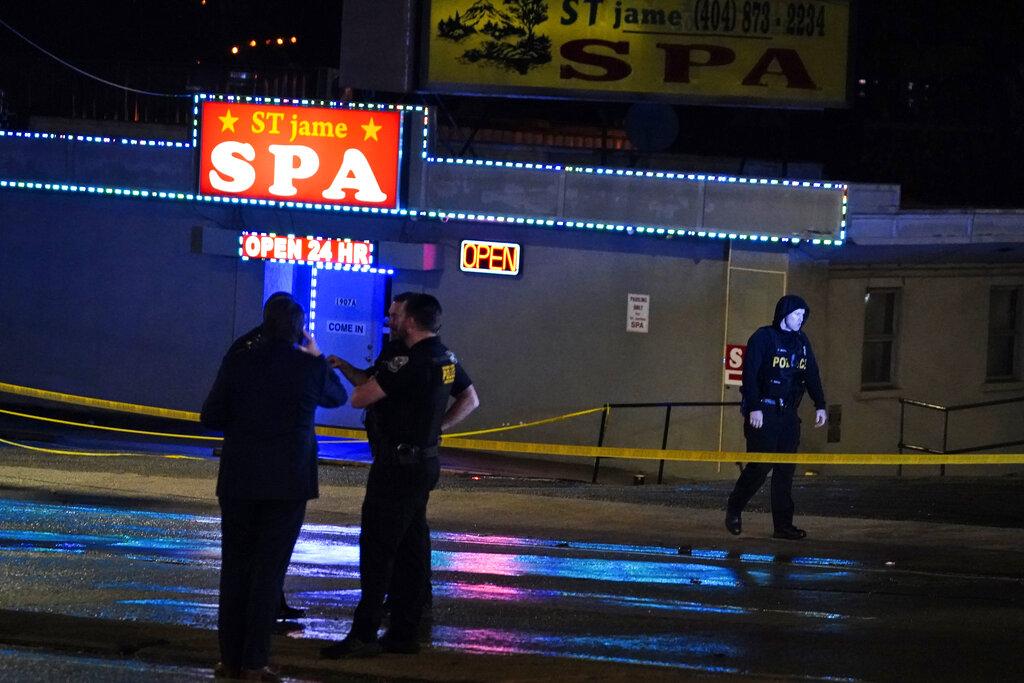 Law enforcement officials confer outside a massage parlor following a shooting on Tuesday, March 16, 2021, in Atlanta. (AP Photo / Brynn Anderson)