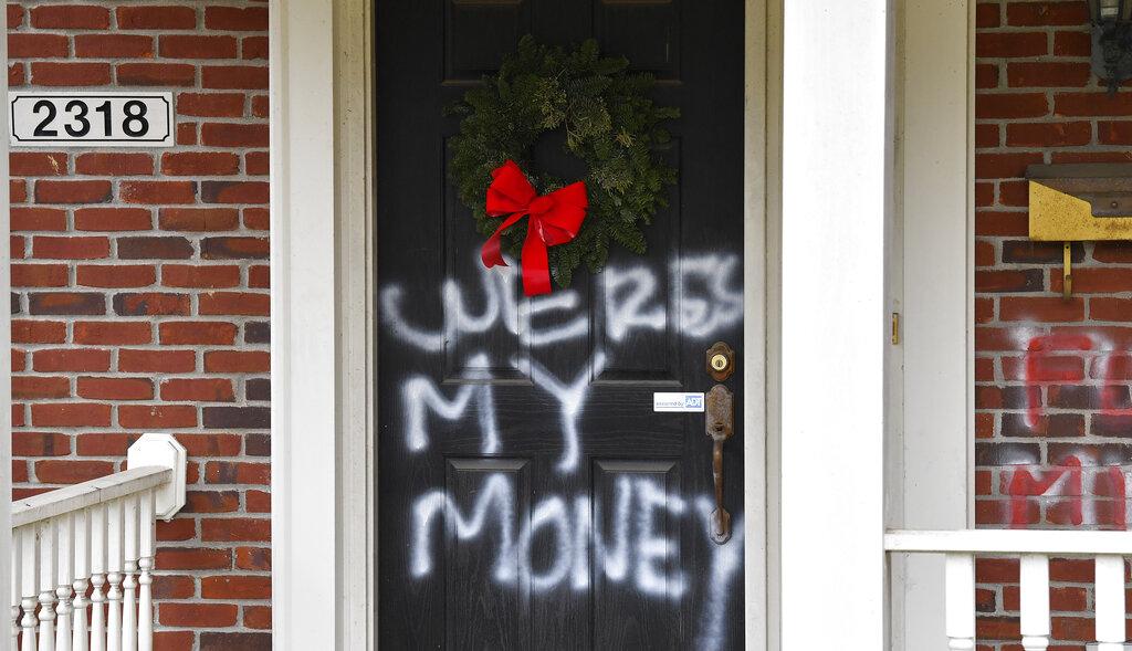 Graffiti reading, “Where’s my money” is seen on a door of the home of Senate Majority Leader Mitch McConnell, R-Ky., in Louisville, Ky., on Saturday, Jan. 2, 2021. (AP Photo /T imothy D. Easley)