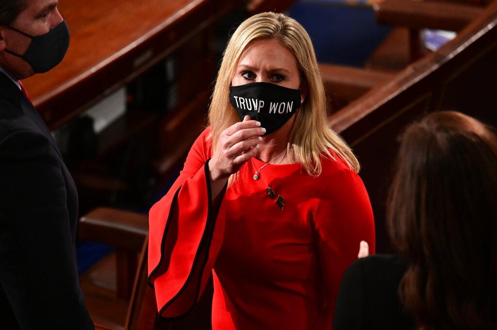 Rep. Marjorie Taylor Greene, R-Ga., wears a “Trump Won” face mask as she arrives on the floor of the House to take her oath of office on opening day of the 117th Congress at the U.S. Capitol in Washington, Sunday, Jan. 3, 2021. (Erin Scott / Pool via AP)