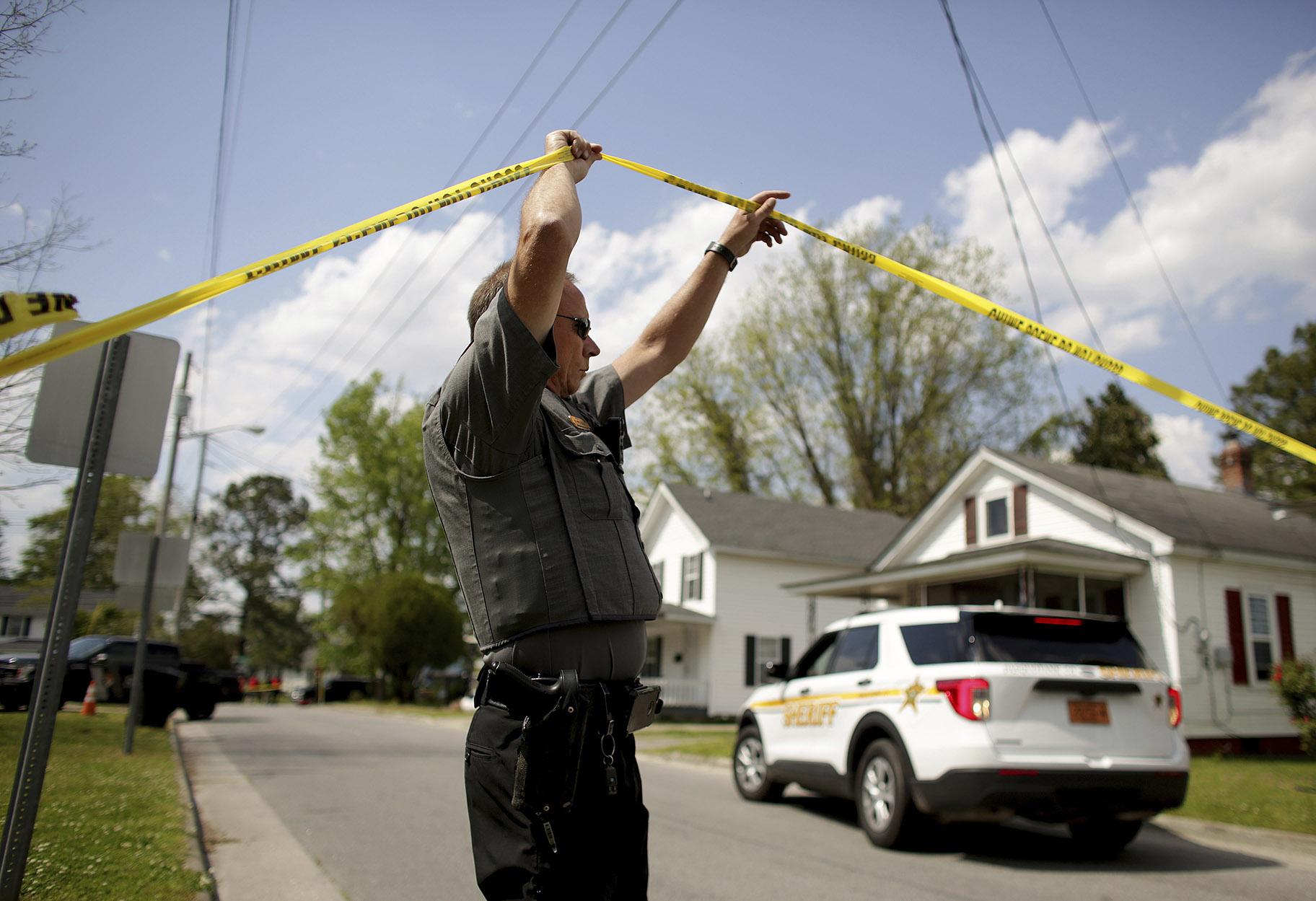 Law enforcement investigate the scene of a shooting, Wednesday, April 21, 2021 in Elizabeth City, N.C. At least one law enforcement officer with a sheriff’s department in North Carolina shot and killed a man while executing a search warrant Wednesday, the sheriff’s office said. (Stephen M. Katz / The Virginian-Pilot via AP)