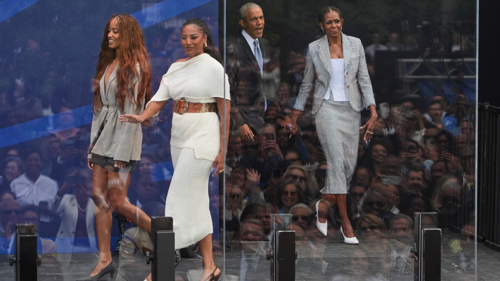 Former President Barack Obama, back center, and former first lady Michelle Obama, right, arrive on stage with their daughters, Sasha and Malia Obama, during the dedication ceremony for the Obama Presidential Center, Thursday, June 18, 2026, in Chicago. (AP Photo / Jeff Roberson)
