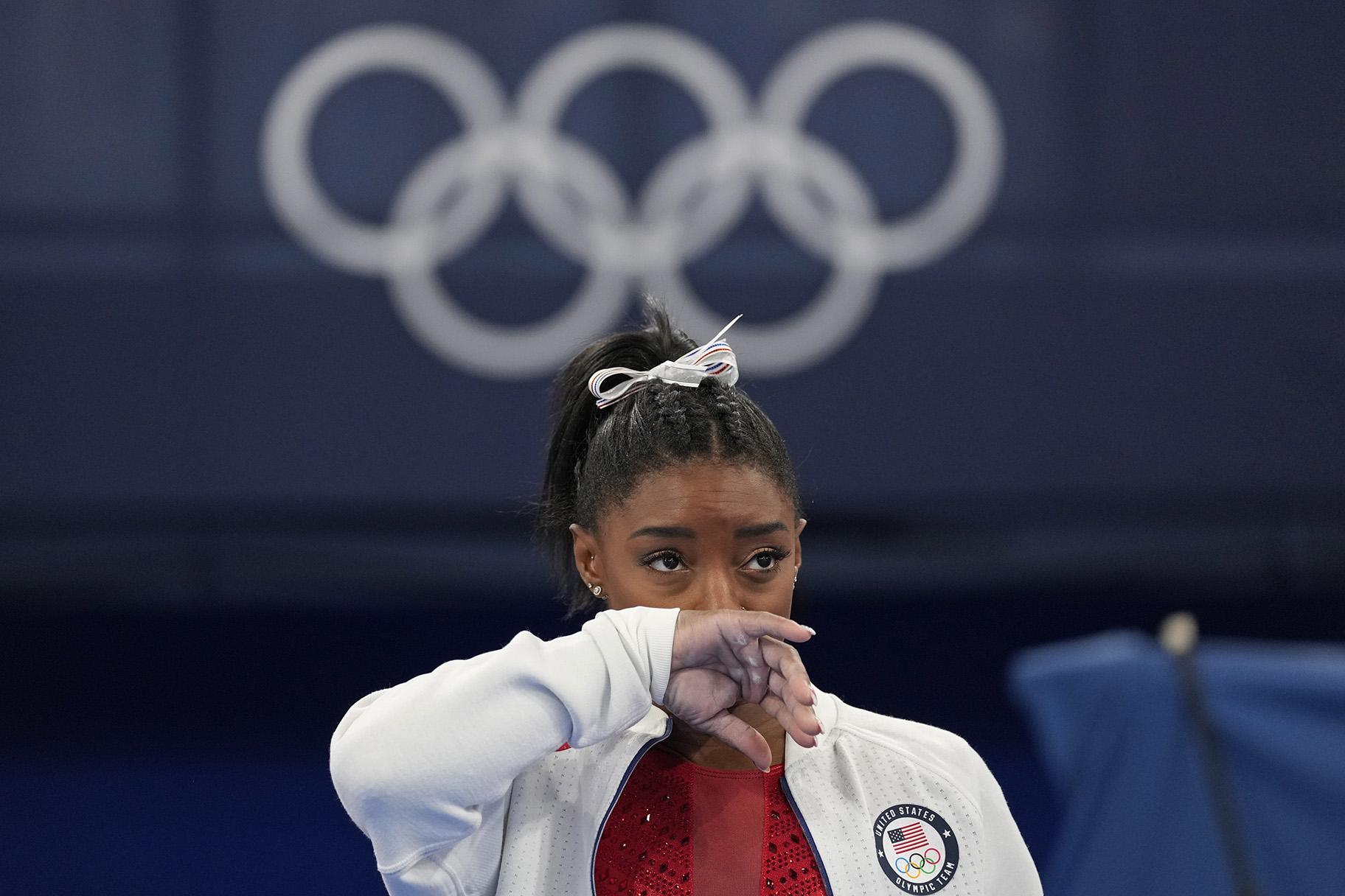 Simone Biles, of the United States, watches gymnasts perform after an apparent injury, at the 2020 Summer Olympics, Tuesday, July 27, 2021, in Tokyo. Biles withdrew from the team finals. (AP Photo / Ashley Landis)