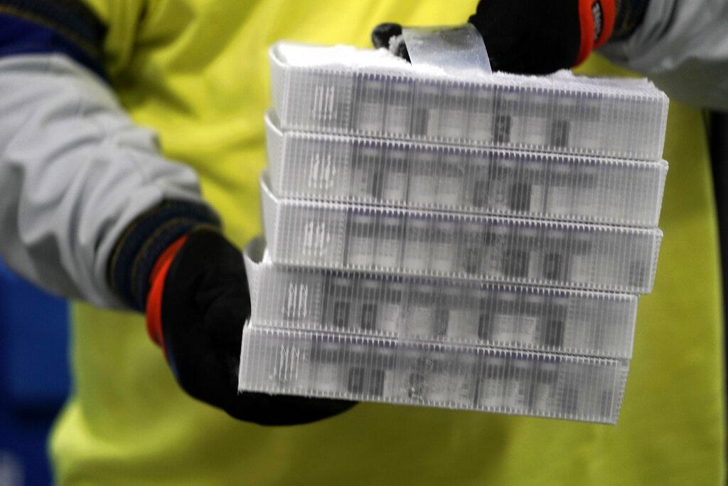 Boxes containing the Pfizer-BioNTech COVID-19 vaccine are prepared to be shipped at the Pfizer Global Supply Kalamazoo manufacturing plant in Portage, Mich., Sunday, Dec. 13, 2020. (AP Photo / Morry Gash, Pool)