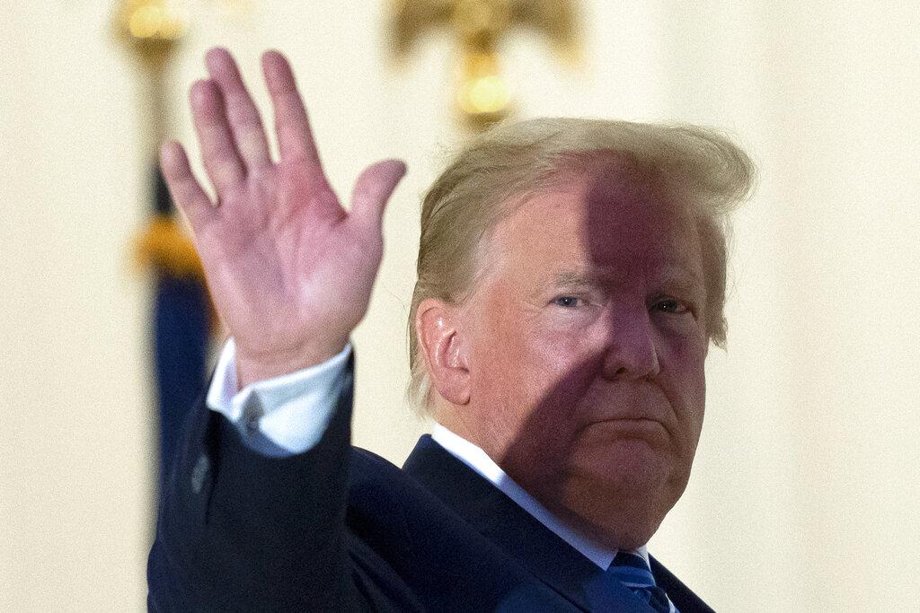 President Donald Trump waves from the Blue Room Balcony upon returning to the White House Monday, Oct. 5, 2020, in Washington, after leaving Walter Reed National Military Medical Center, in Bethesda, Md (AP Photo / Alex Brandon)