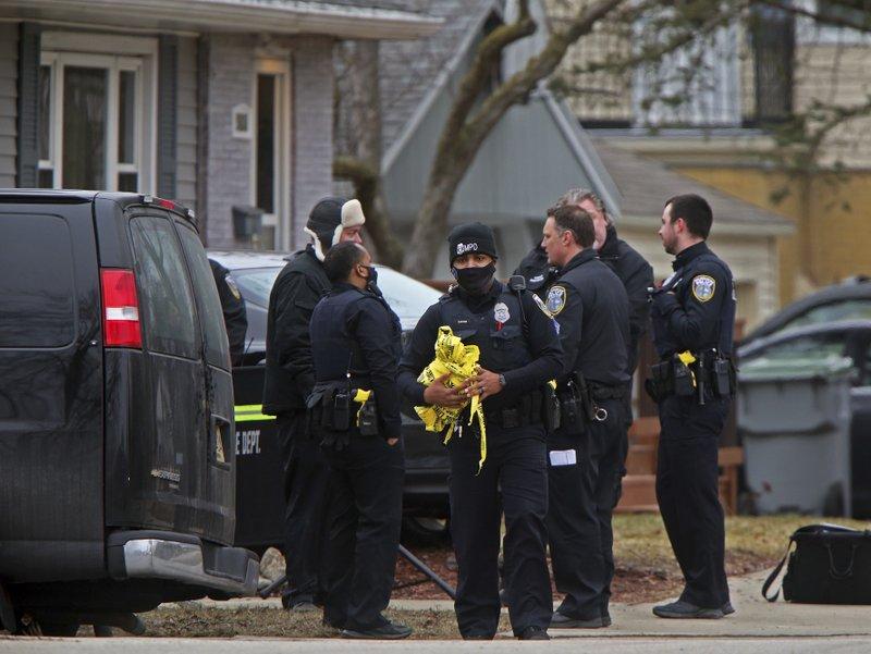 Milwaukee Police Officers and other investigators work near the intersection of North 92nd and West Townsend streets in Milwaukee, Wednesday, March 17, 2021. (Angela Peterson / Milwaukee Journal-Sentinel via AP)