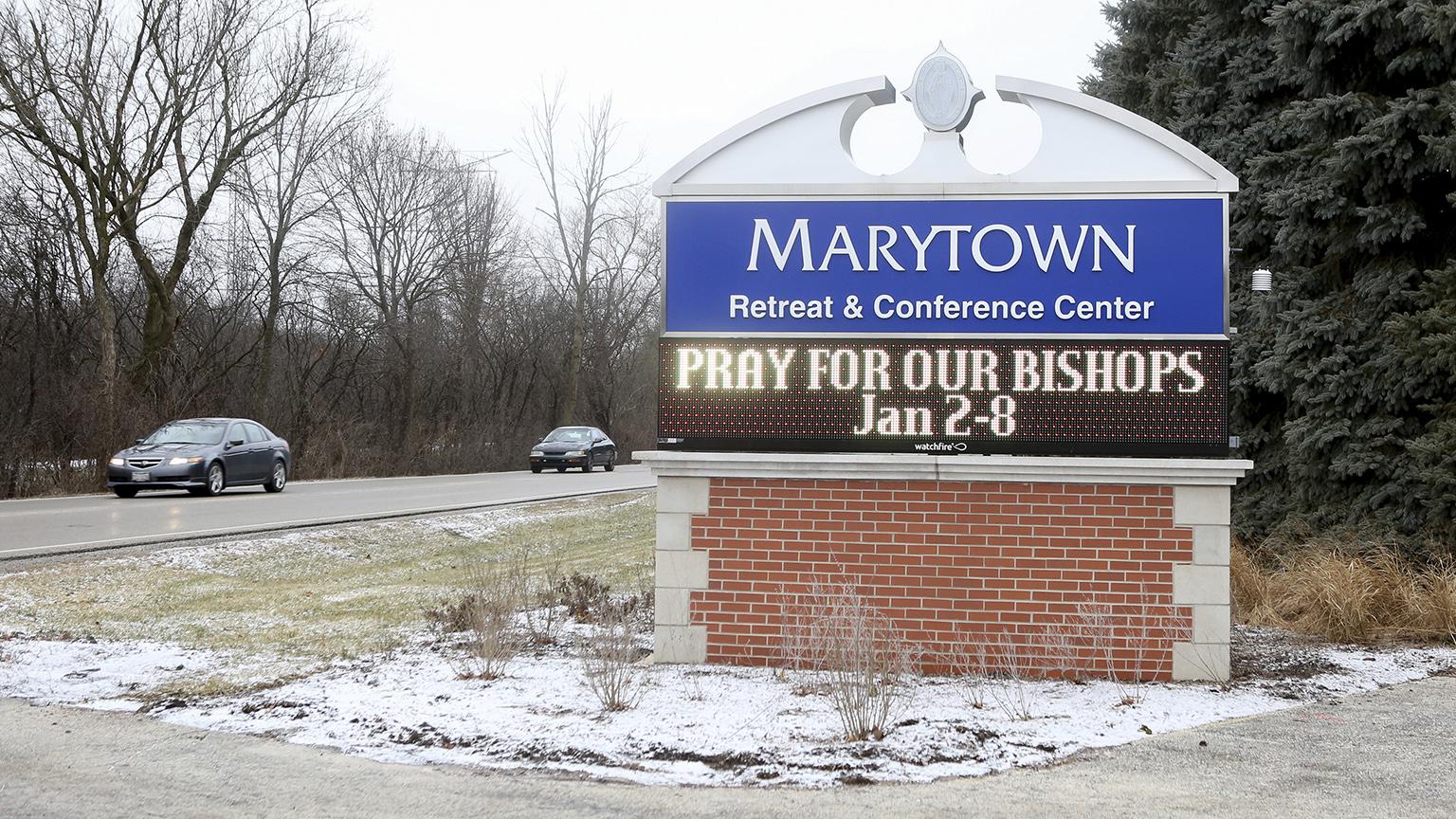 A sign outside the Mundelein Seminary asks the faithful to pray for U.S.-based Roman Catholic bishops gathering there for a weeklong prayer retreat, Wednesday, Jan. 2, 2019, in Mundelein, Illinois. (AP Photo / Teresa Crawford)