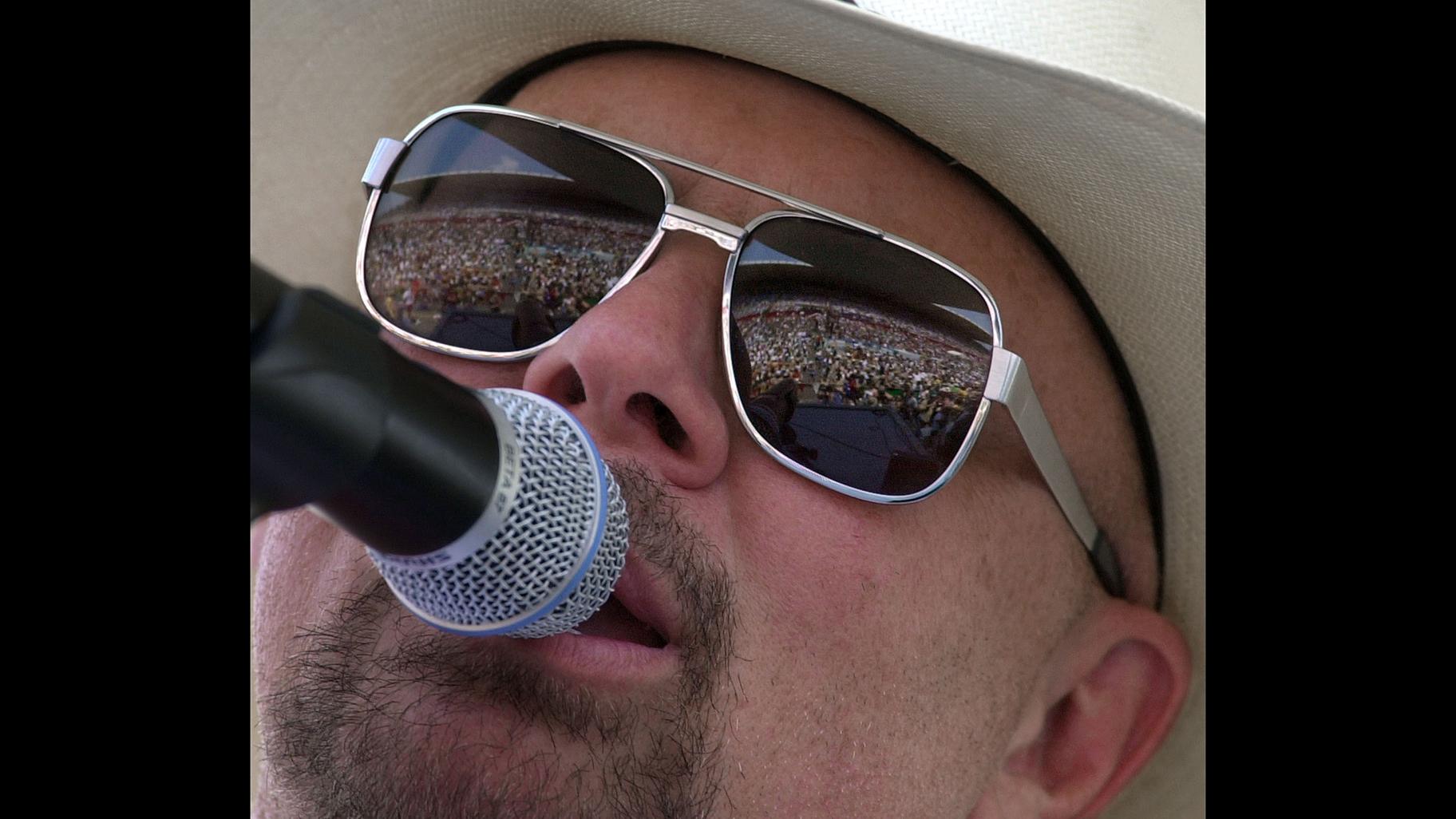 In this June 12, 2000 file photo, country music fans are reflected in the glasses of Southern rock group Confederate Railroad lead singer Danny Shirley during a concert in Nashville, Tennessee. (AP Photo / Mark Humphrey)