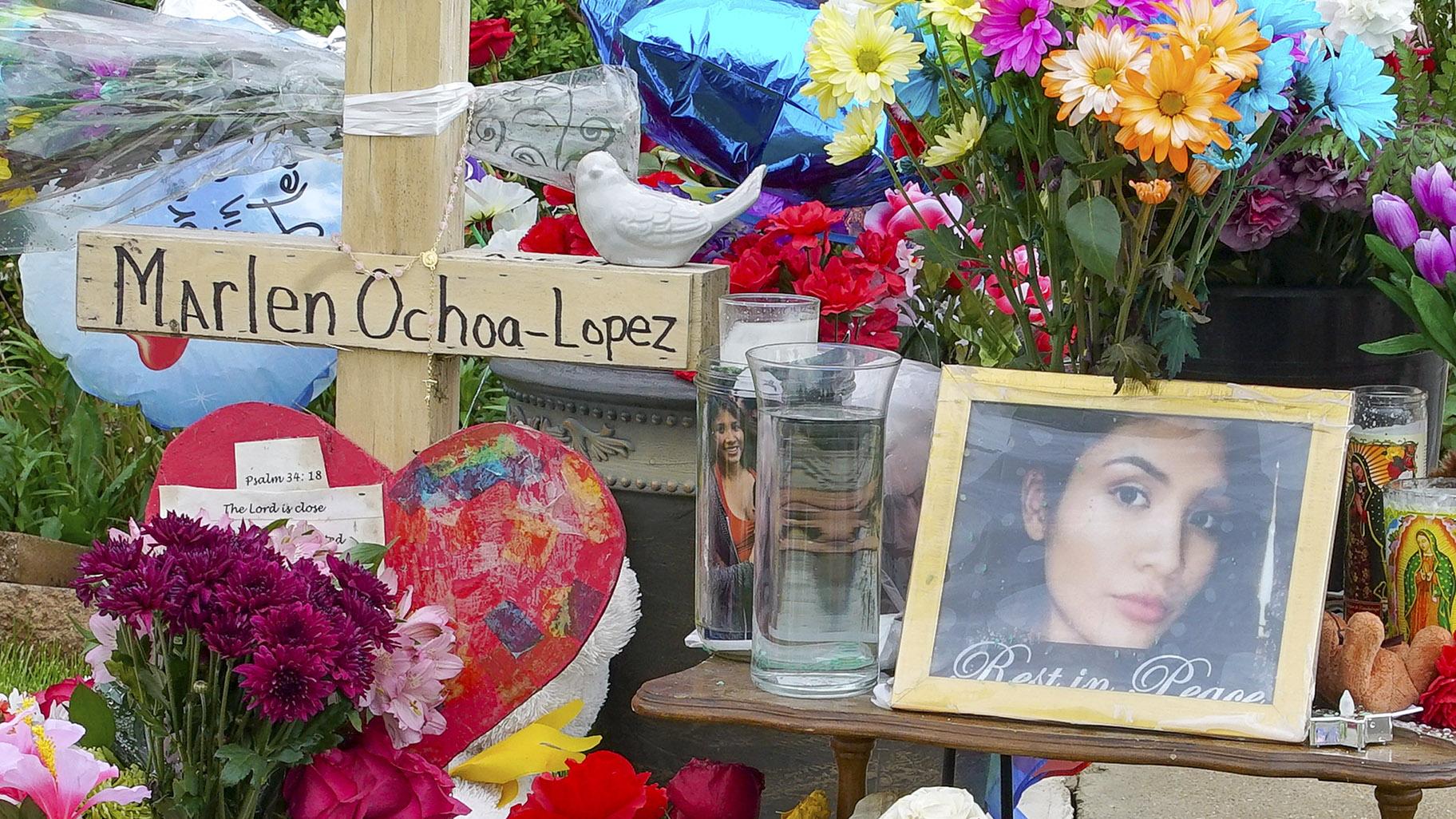 A memorial of flowers, balloons, a cross and photo of Marlen Ochoa-Lopez are displayed on the lawn, Friday, May 17, 2019 in Chicago, outside the home where Ochoa-Lopez was murdered last month. (AP Photo / Teresa Crawford)