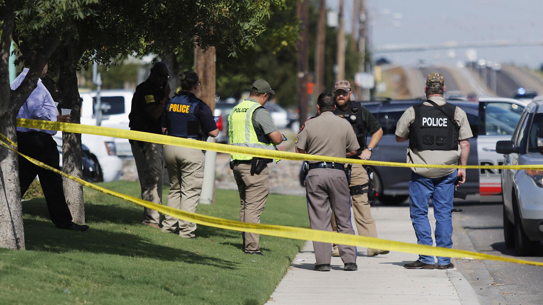 Authorities cordon off a part of the sidewalk in the 5100 block of E. 42nd Street in Odessa, Texas, Saturday, Aug. 31, 2019. Several people were dead after a gunman who hijacked a postal service vehicle in West Texas shot more than 20 people, authorities said Saturday. The gunman was killed and a few law enforcement officers were among the injured. (Mark Rogers / Odessa American via AP)